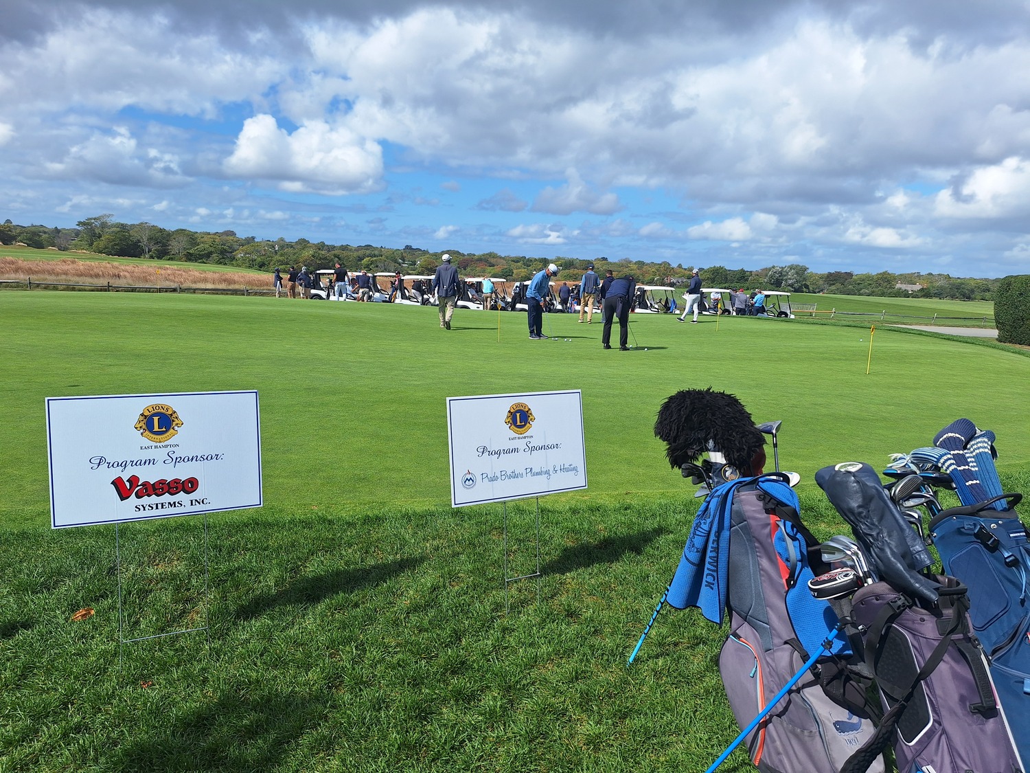 The East Hampton Lions Foundation Inc.  recently hosted its 37th invitational golf outing at the prestigious Maidstone Club. Proceeds will go to the many local organizations that the club supports. Among the top level sponsors were Mickey’s Carting, Riverhead Building Supply, Bistrian Materials, Prado Plumbing, and Rosemar. Lions volunteers Darius Narizzano (standing) and Chris Sarlo manned the registration table and handed out the gift bags to each golfer. COURTESY EAST HAMPTON LIONS CLUB