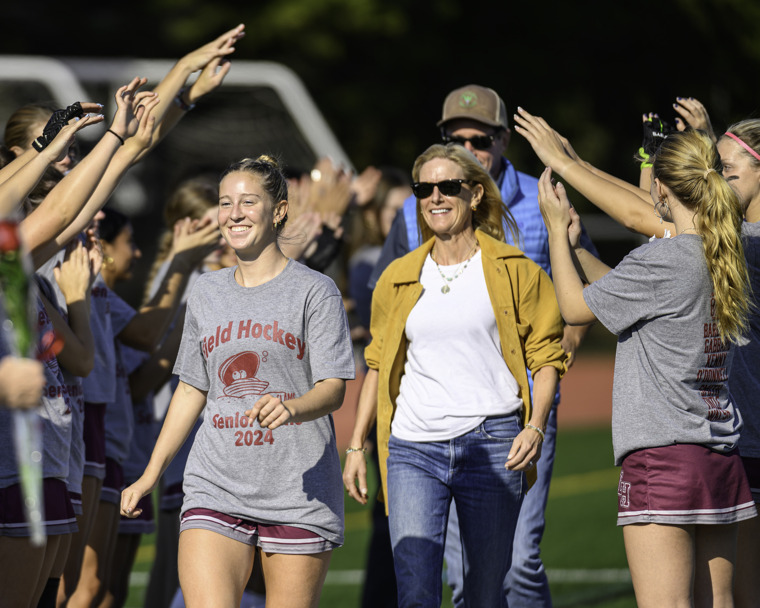 Ava Tintle leads her mother and father in Senior Day festivities on Friday.   MARIANNE BARNETT