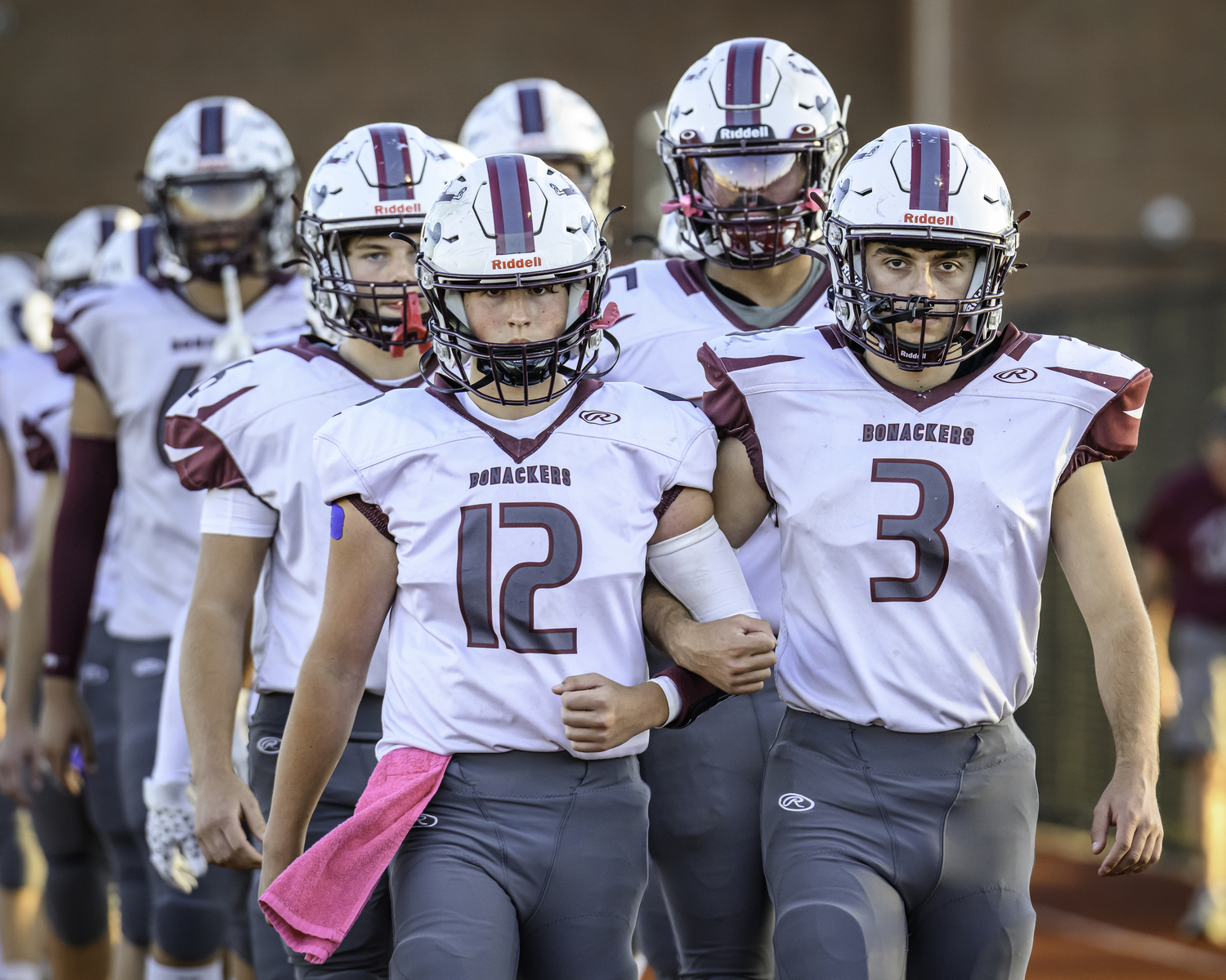 Theo Ball and Brandon Bistrian lead the Bonackers onto the field at Islip on Saturday evening.   MARIANNE BARNETT