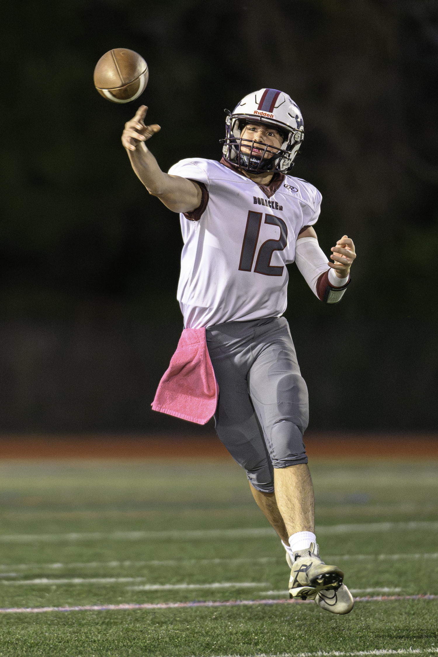 East Hampton junior quarterback Theo Ball throws the ball on the run.  MARIANNE BARNETT