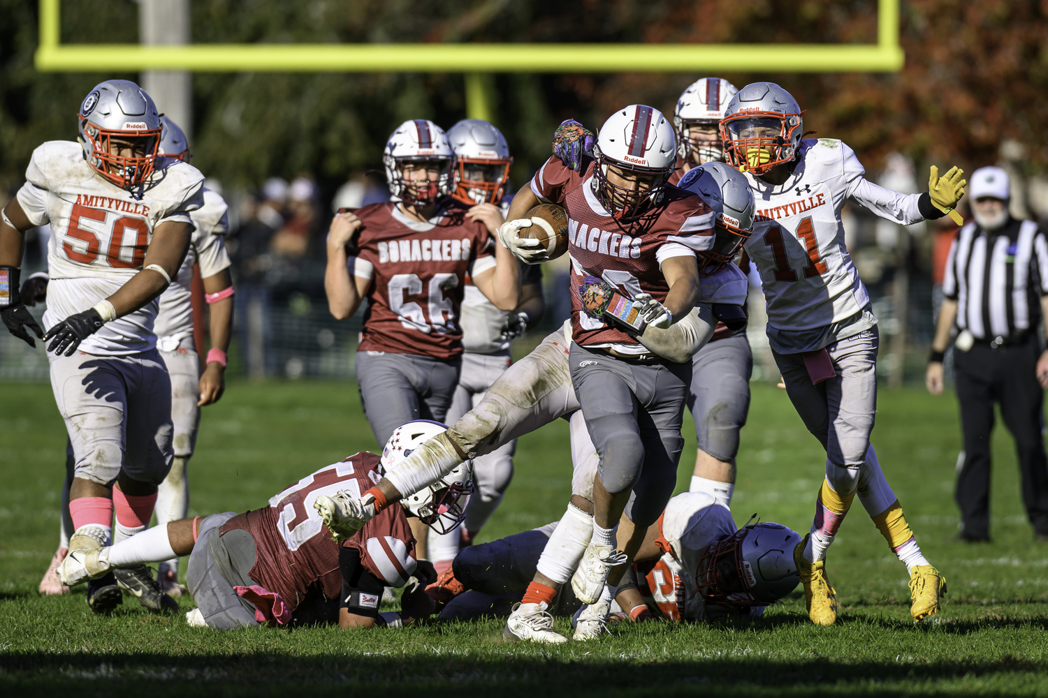 Pierson senior Gio Vaccari breaks through the line with an Amityville defender on his back.  MARIANNE BARNETT