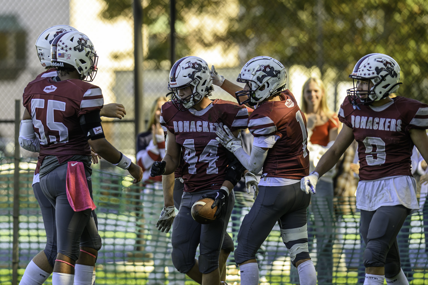 East Hampton sophomore Jackson Ronick gets congratulated by teammates after scoring the game's first touchdown on Saturday.  MARIANNE BARNETT