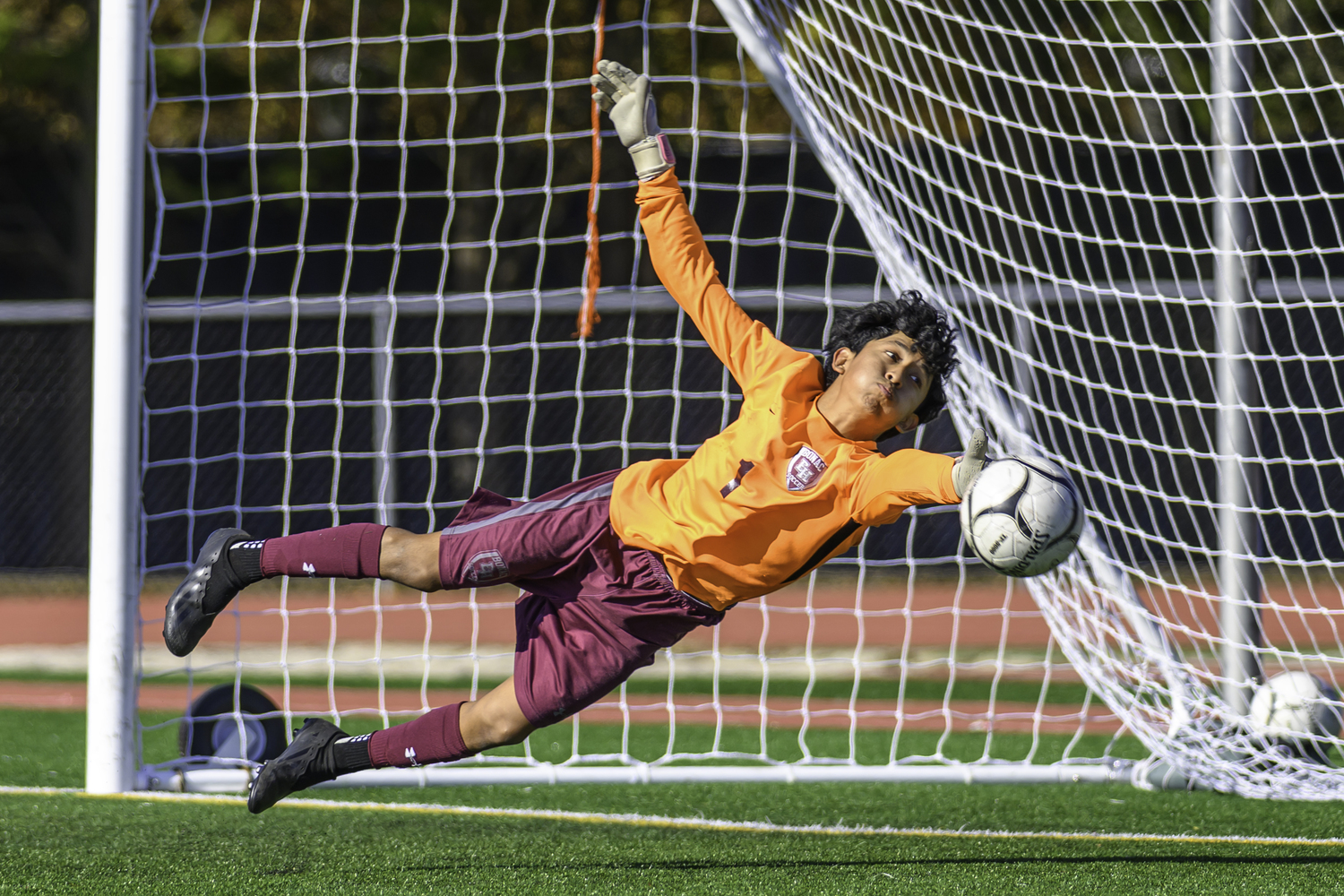 East Hampton sophomore goalie Brandon Encalada makes one of his many saves on Saturday.  MARIANNE BARNETT