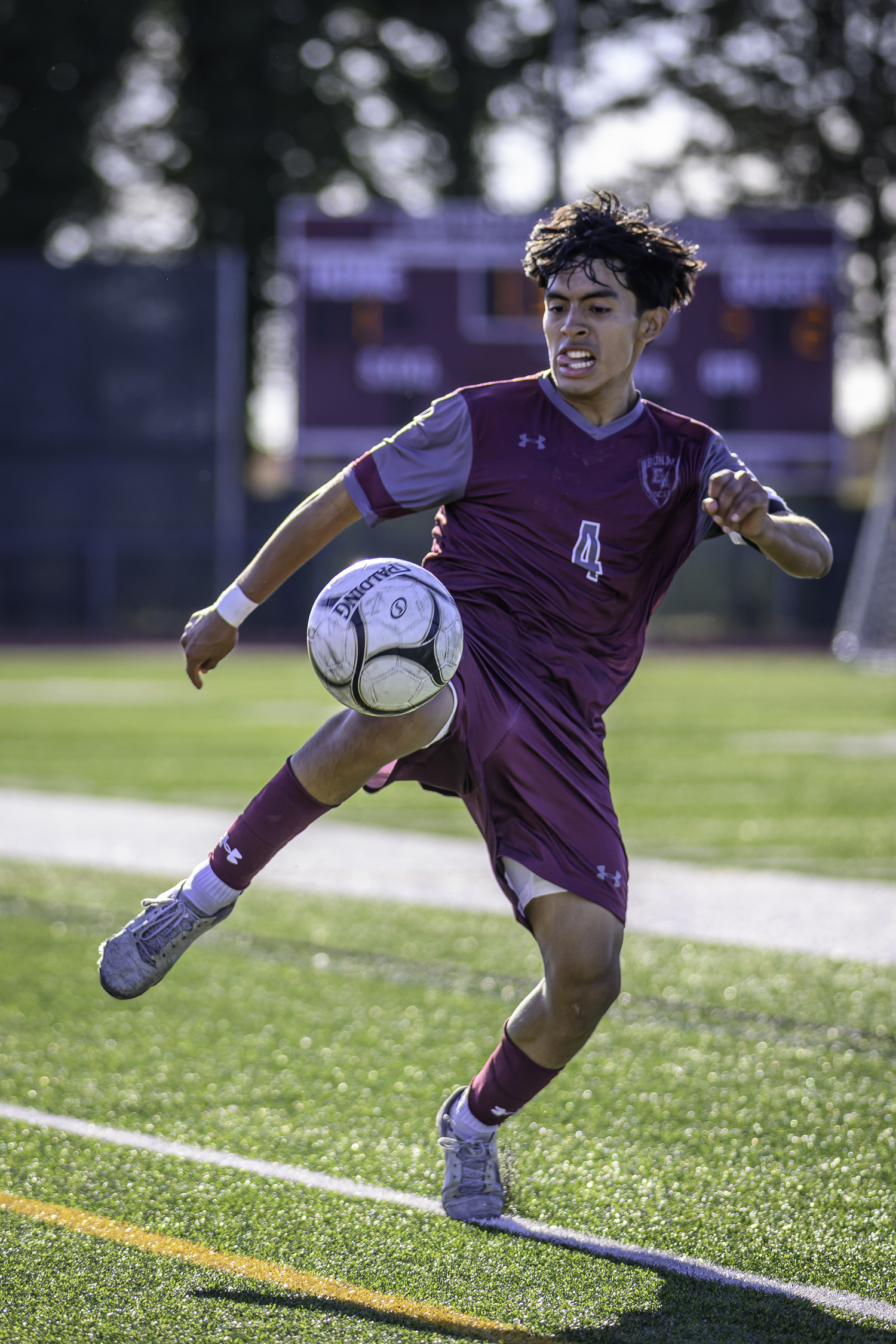 East Hampton senior Jonathan Armijos works hard to keep the ball inbounds with his team trailing and the clock winding down.  MARIANNE BARNETT