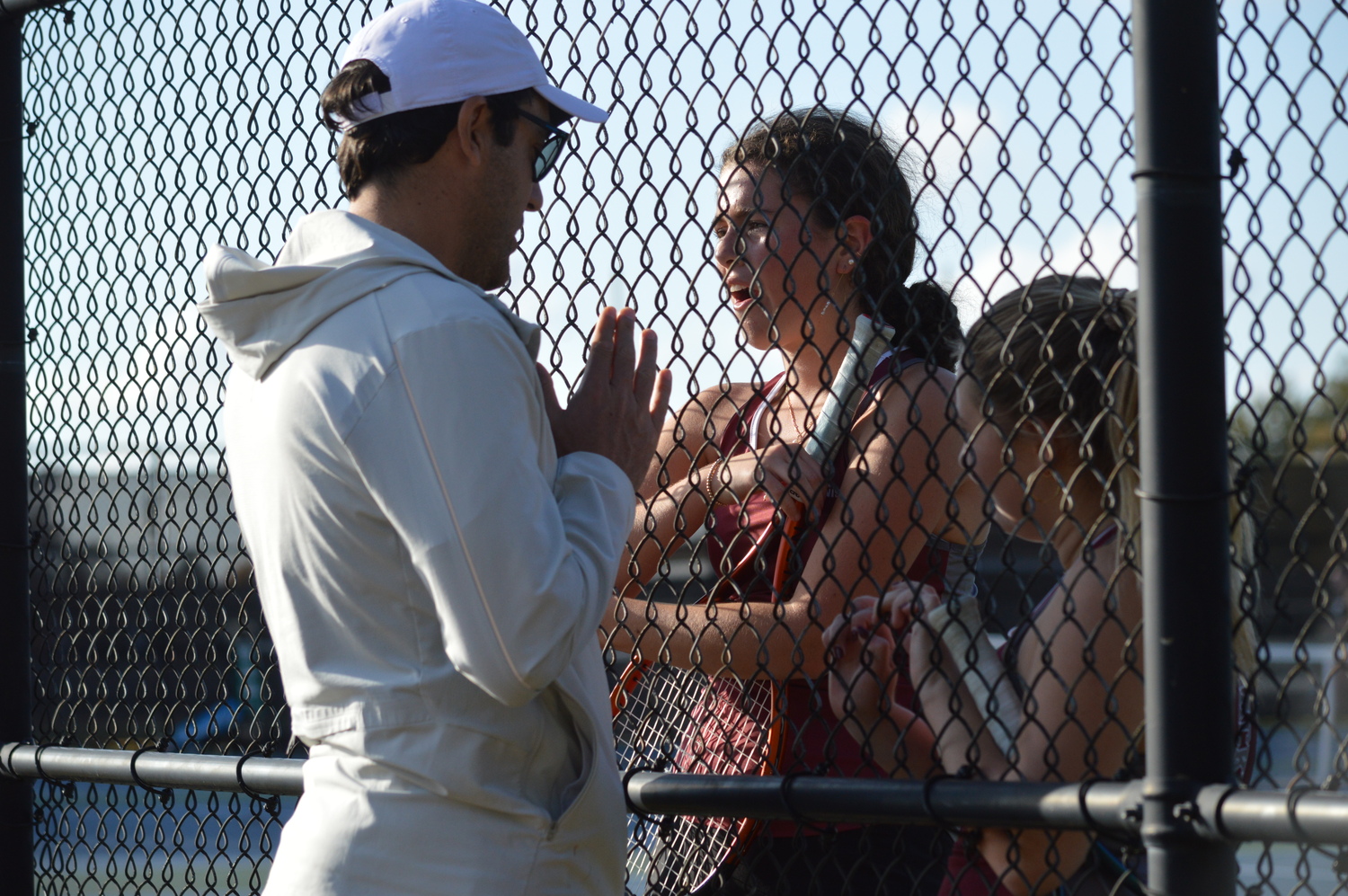 East Hampton tennis coach Pablo Montesi talking to Ella Menu and Ava Mintz during their doubles match on Wednesday.   GAVIN MENU