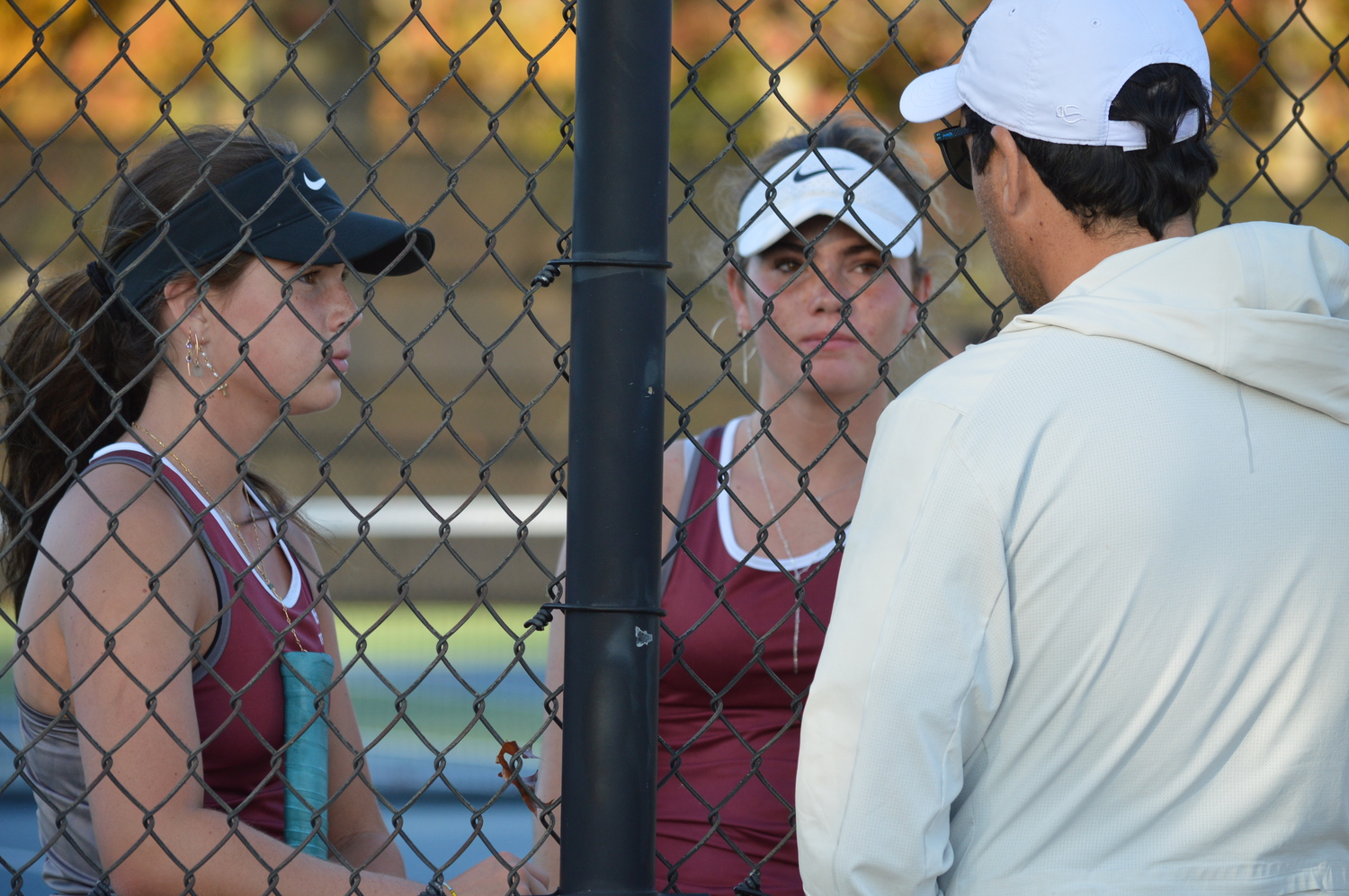 Colleen McKee and Caleigh Barletta getting advice from their coach, Pablo Montesi.  GAVIN MENU