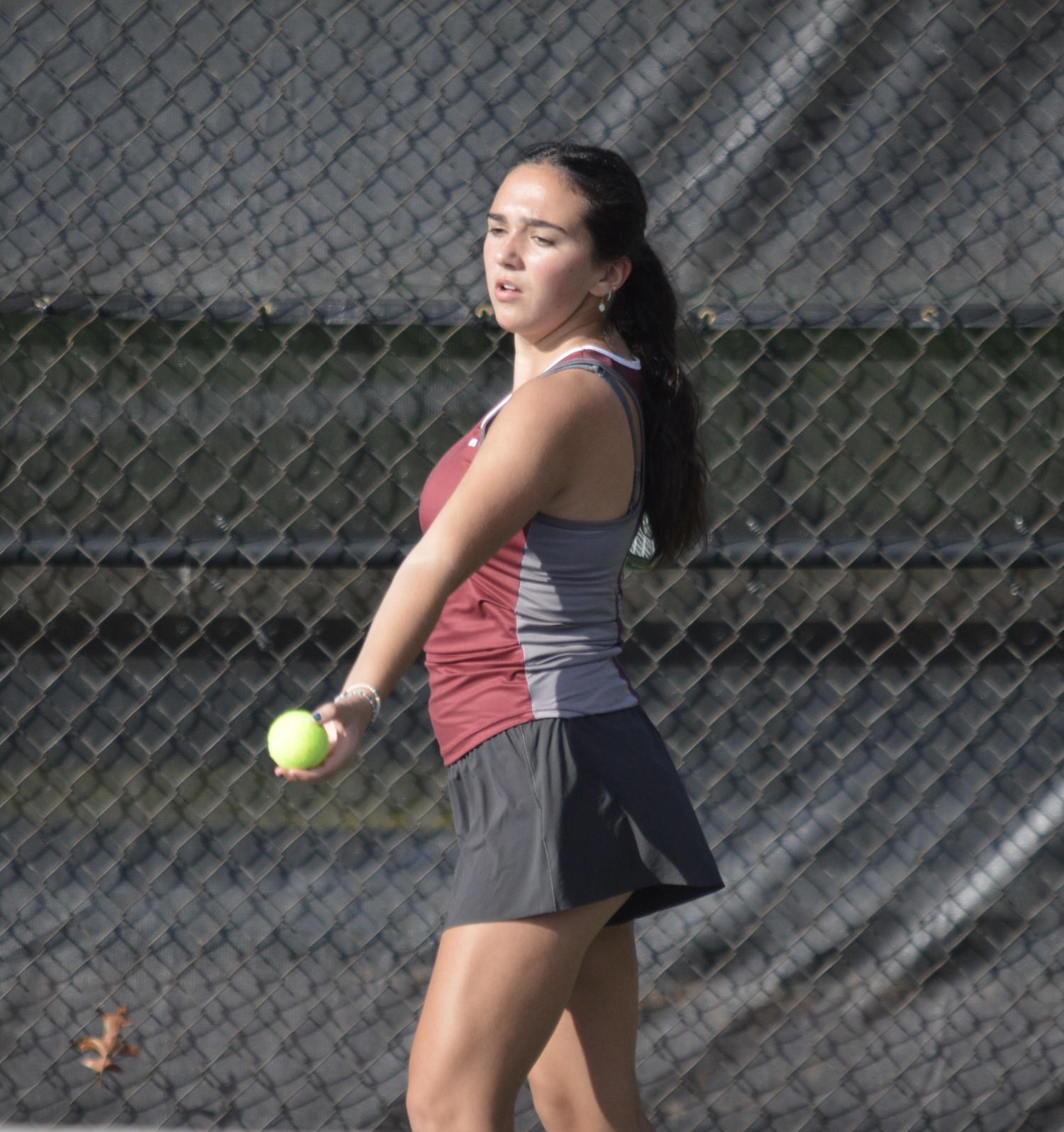 Junior Sophia Sanchez-Cleary preparing to serve during her match at fourth doubles on Wednesday.    GAVIN MENU