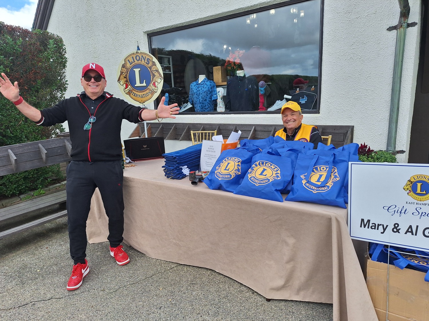 The East Hampton Lions Foundation Inc.  recently hosted its 37th invitational golf outing at the prestigious Maidstone Club. Proceeds will go to the many local organizations that the club supports. Among the top level sponsors were Mickey’s Carting, Riverhead Building Supply, Bistrian Materials, Prado Plumbing, and Rosemar. Lions volunteers Darius Narizzano (standing) and Chris Sarlo manned the registration table and handed out the gift bags to each golfer. COURTESY EAST HAMPTON LIONS CLUB