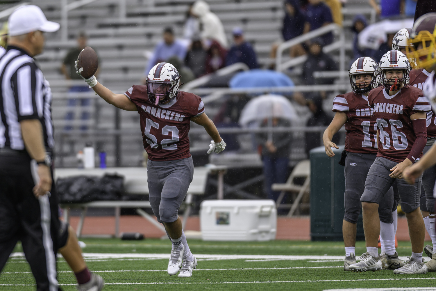 East Hampton's Jake Rivera holds the ball up after recovering a fumble.  MARIANNE BARNETT