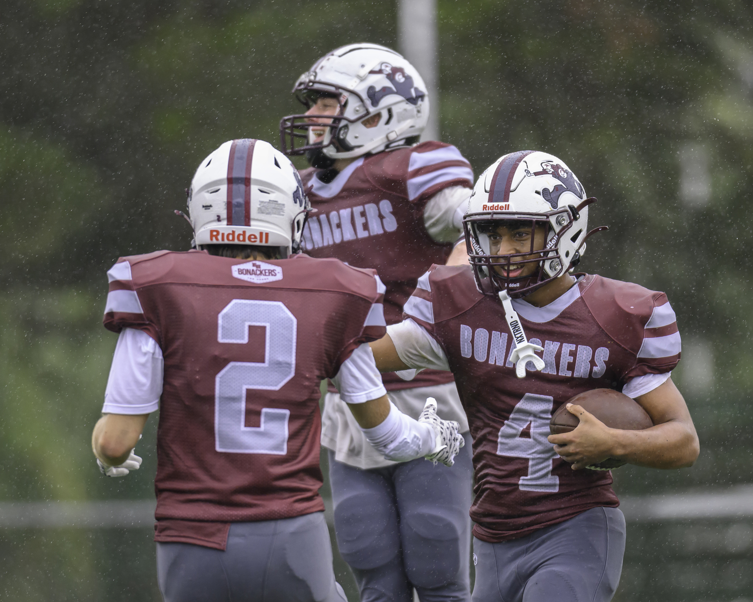 Alex Davis is congratulated by teammate Henry Butler on yet another touchdown.  MARIANNE BARNETT