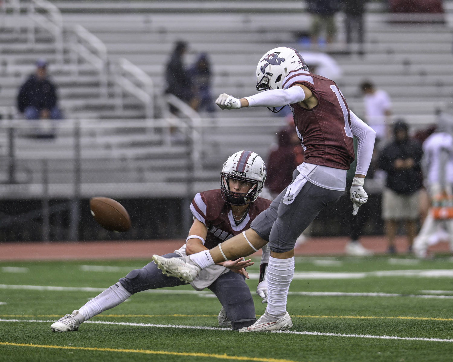 Manny Morales, with Theo Ball holding, kicks a successful extra point.  MARIANNE BARNETT