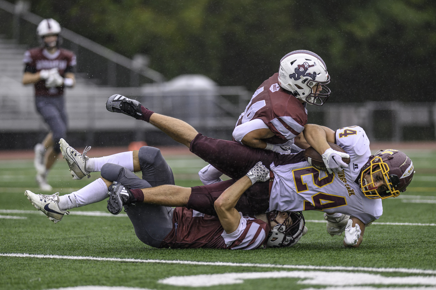 Jackson Ronick teams up with a teammate on a tackle.  MARIANNE BARNETT