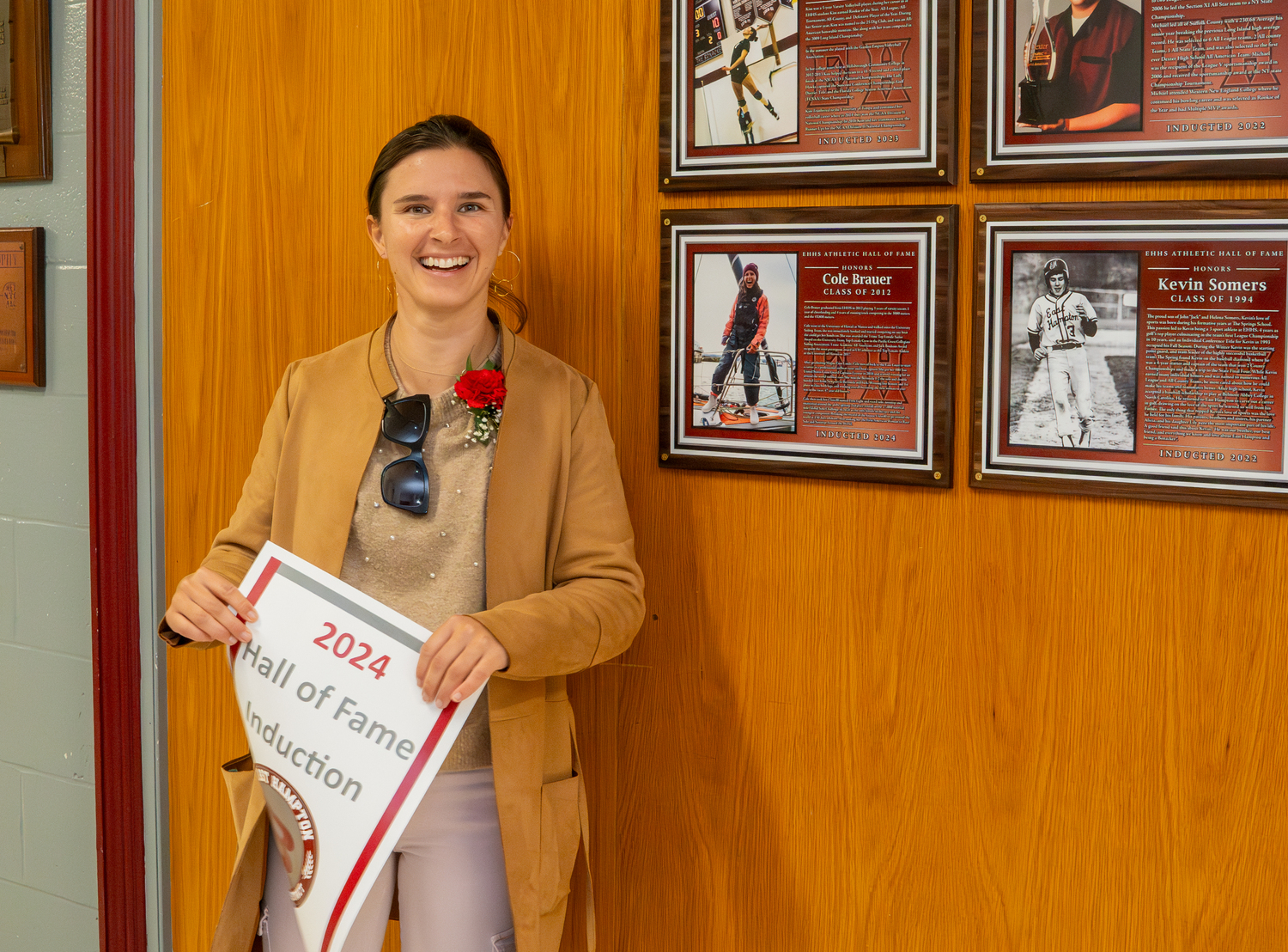 Cole Brauer stands next to her Hall of Fame plaque.   RON ESPOSITO