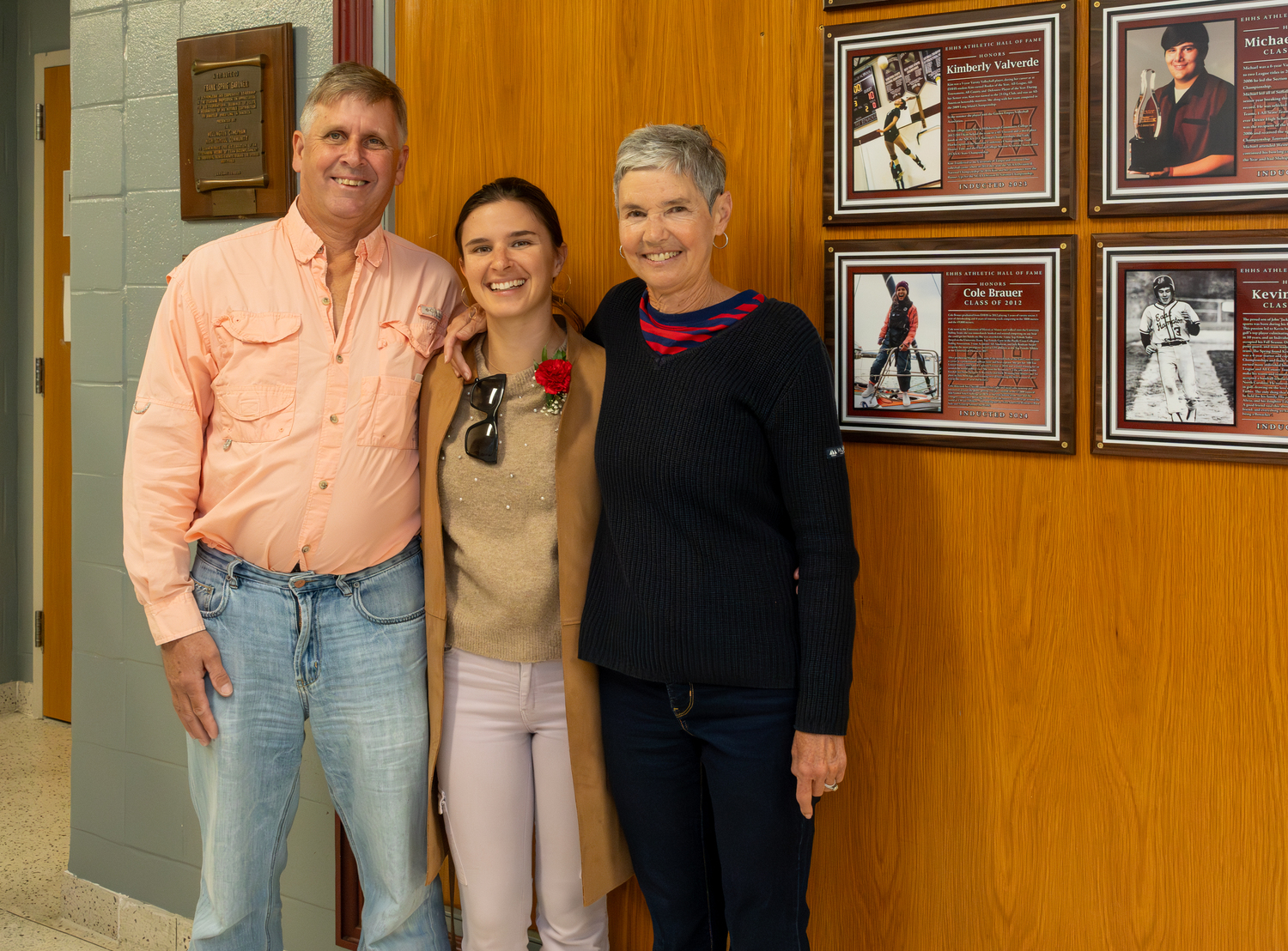 Cole Brauer with her parents after being inducted into the East Hampton Athletic Hall of Fame.   RON ESPOSITO