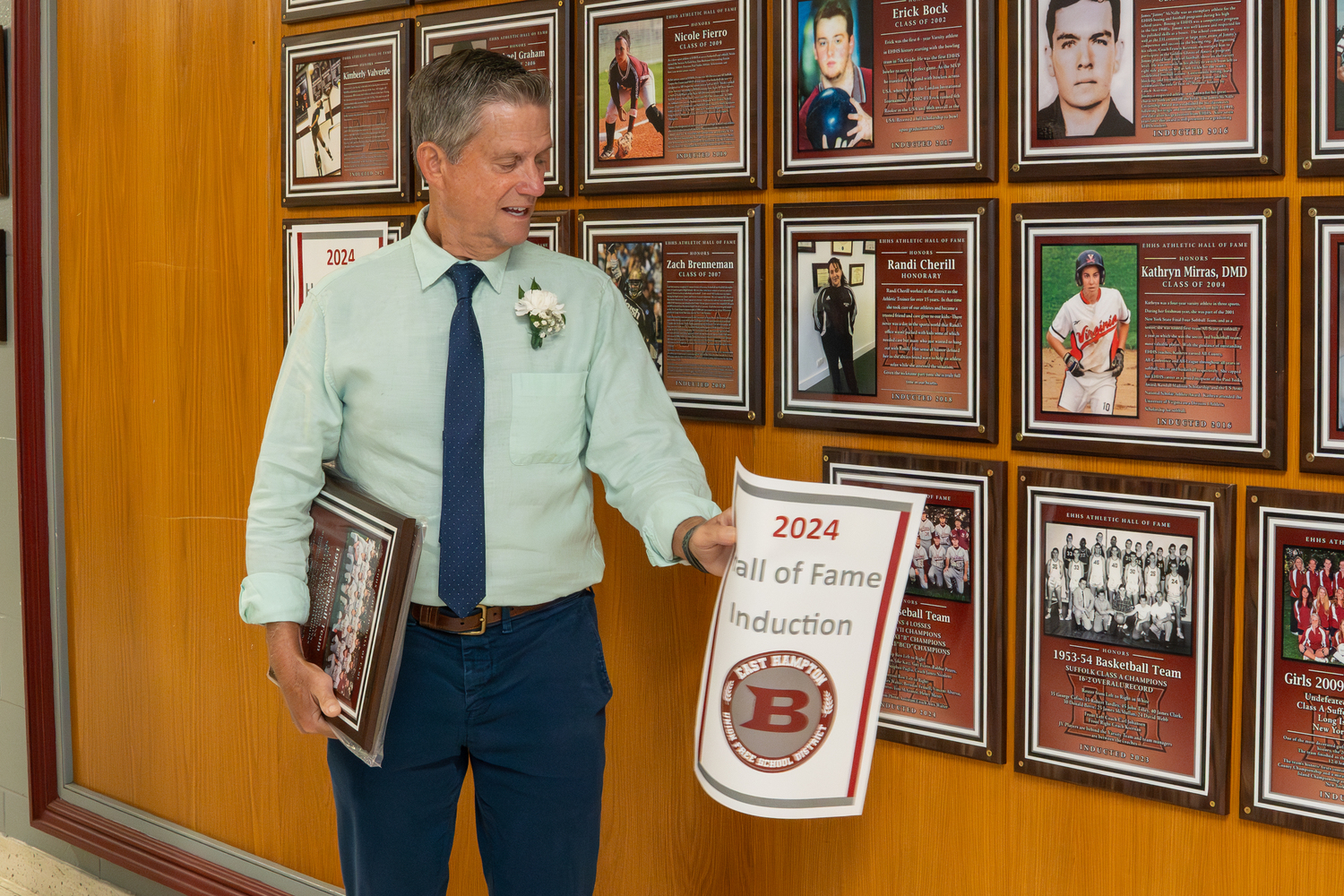 Former baseball head coach Jim Nicoletti unveils the plaque in recognition of the 1995 baseball team.   RON ESPOSITO