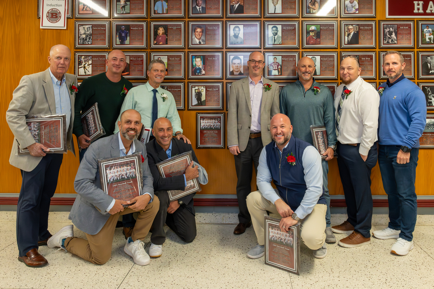 Members of the 1995 baseball team with their plaque right in the middle.  RON ESPOSITO