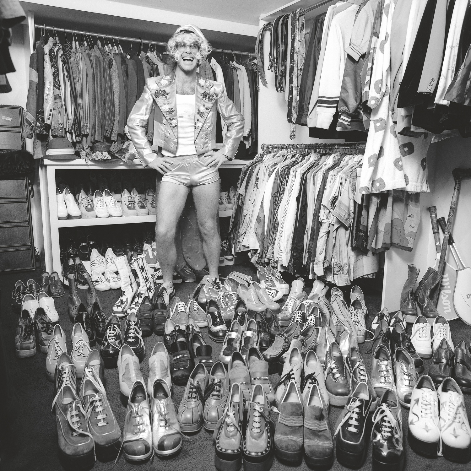 Elton John, 1970s, offering a peek inside his closet. TERRY O'NEILL/ICONIC IMAGES