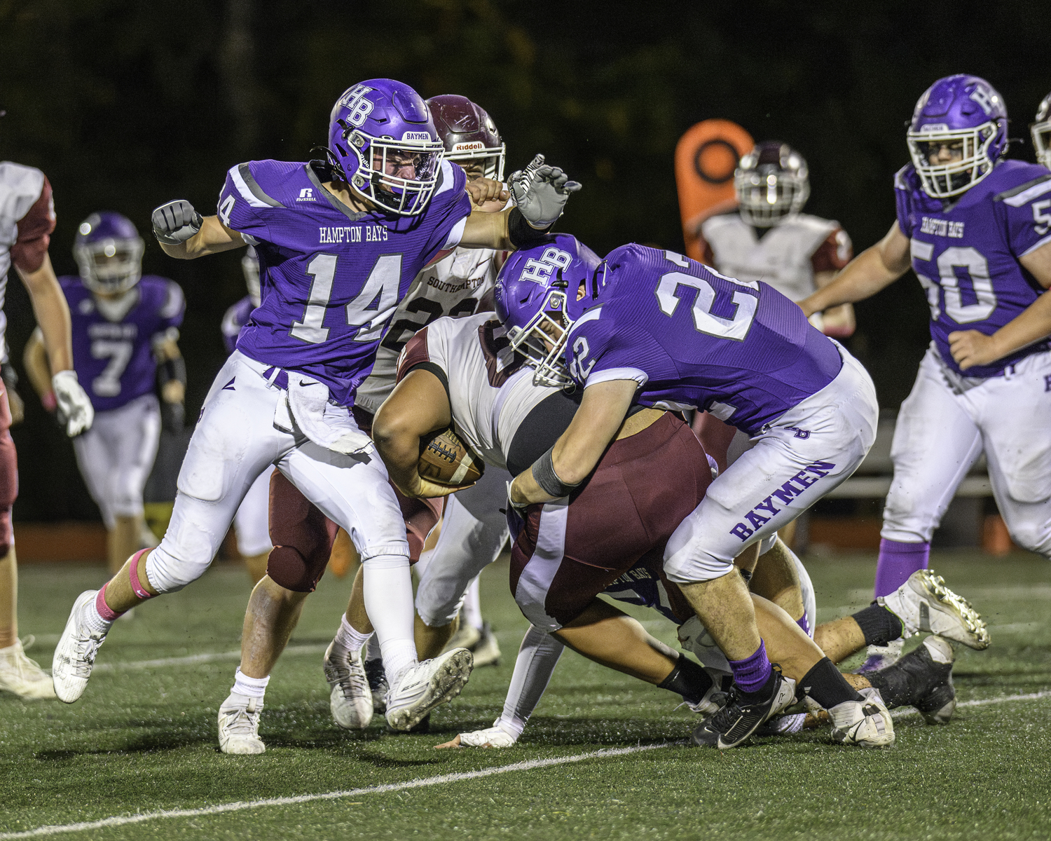 Hampton Bays senior Nate Donahue wraps up Southampton senior Jackson Garcia.   MARIANNE BARNETT