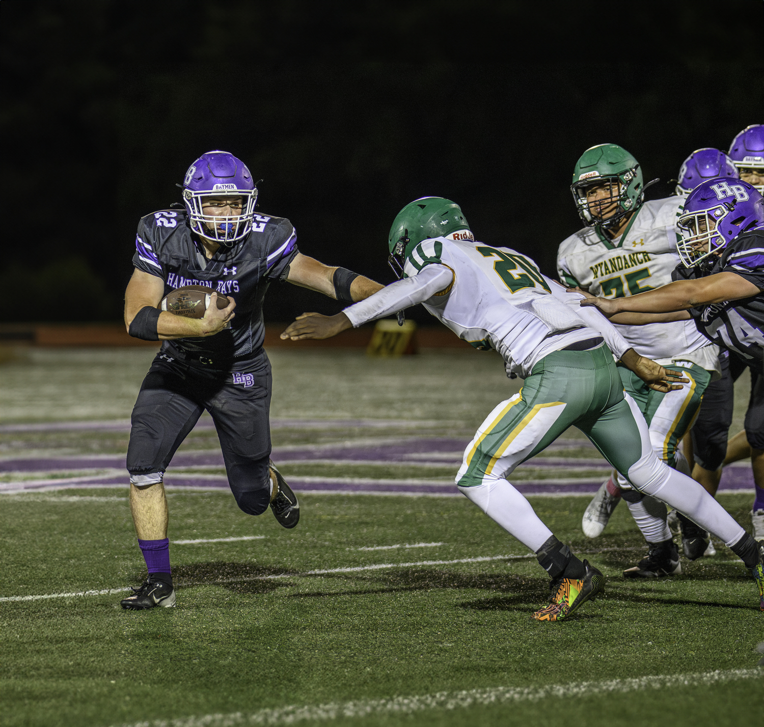 Hampton Bays senior Nate Donahue stiff arms a Wyandanch defender.   MARIANNE BARNETT