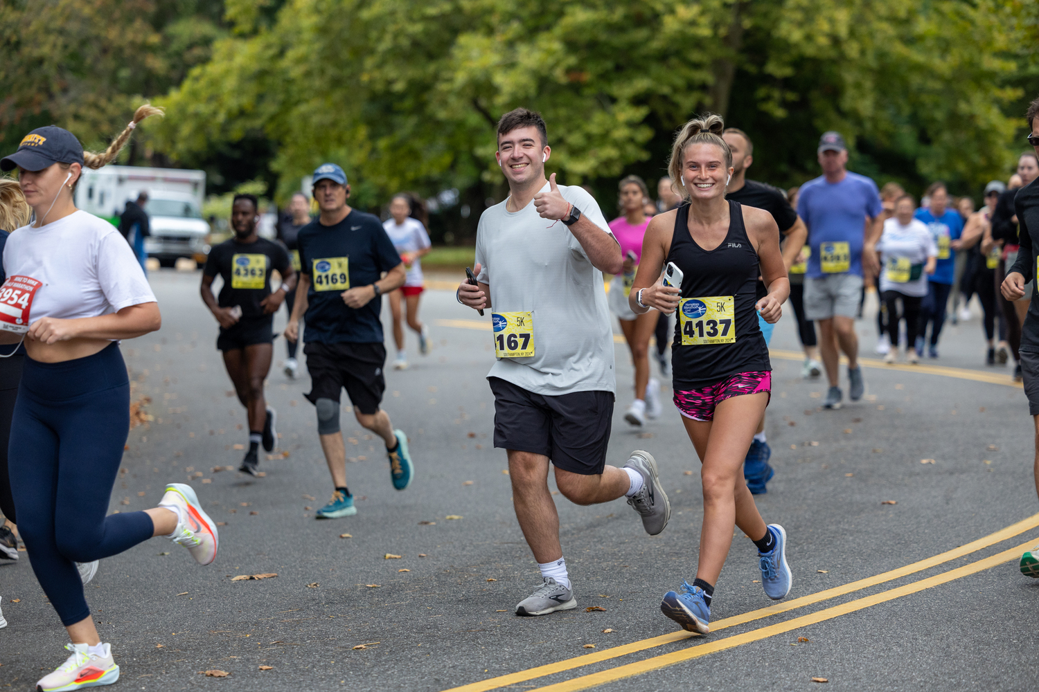 Connor Genitempo gives a thumbs up while running alongside Emily Deangelo.   RON ESPOSITO