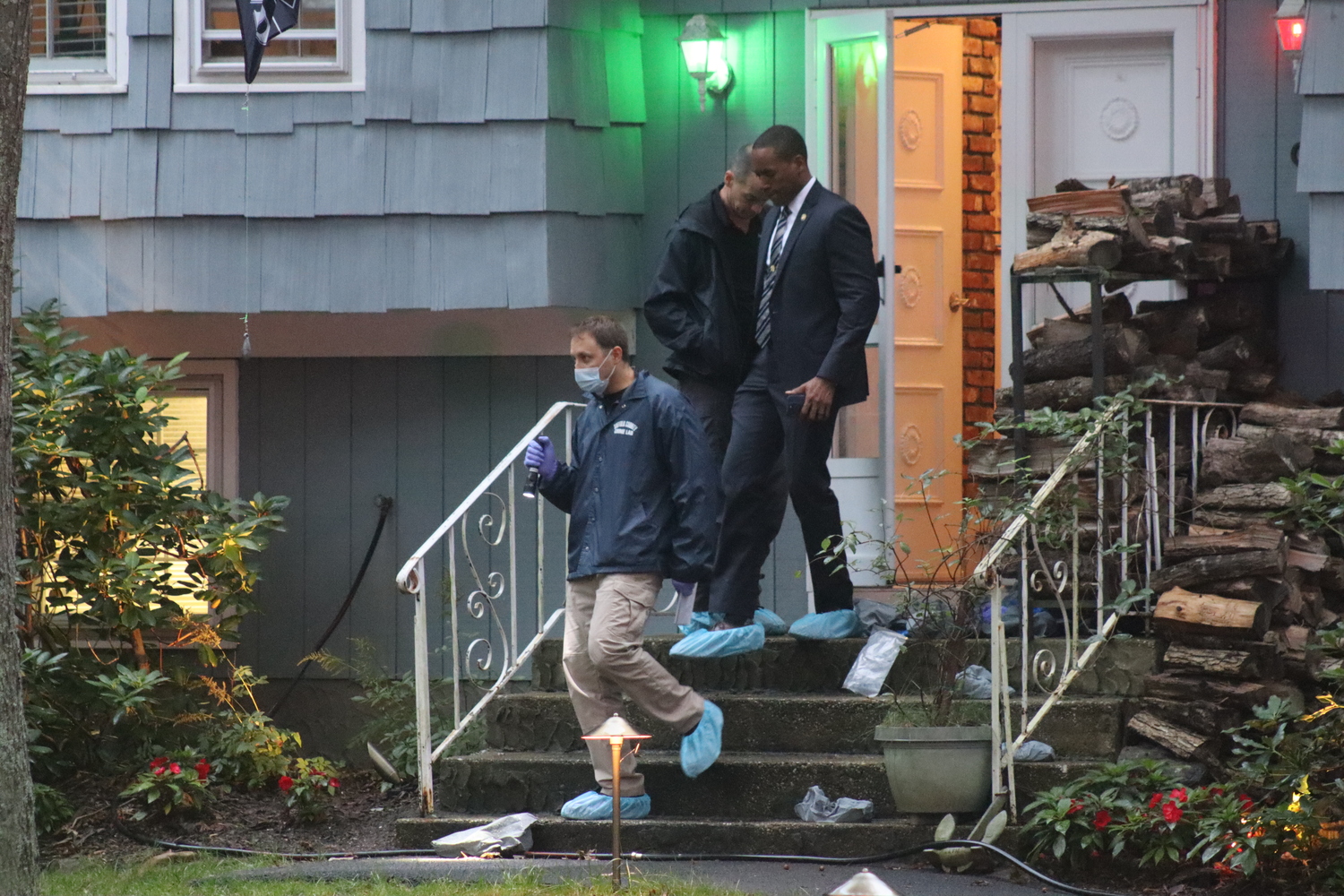 Suffolk County detectives at the scene of a killing in East Quogue on Saturday.