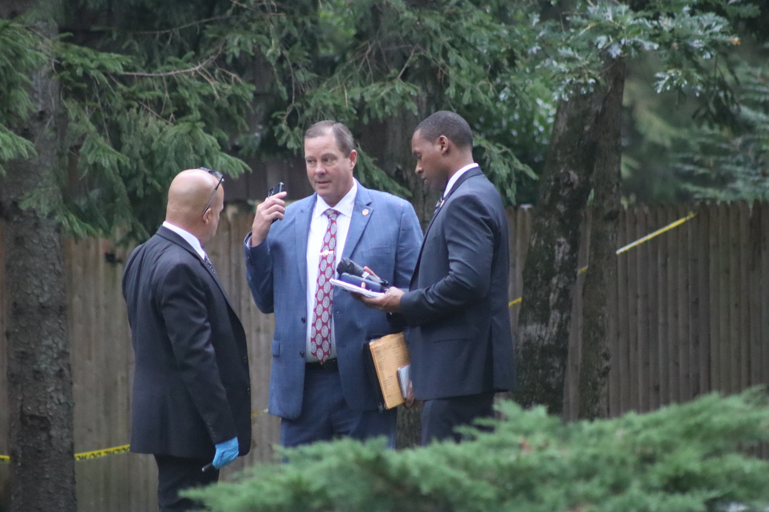 Suffolk County detectives at the scene of a killing in East Quogue on Saturday.