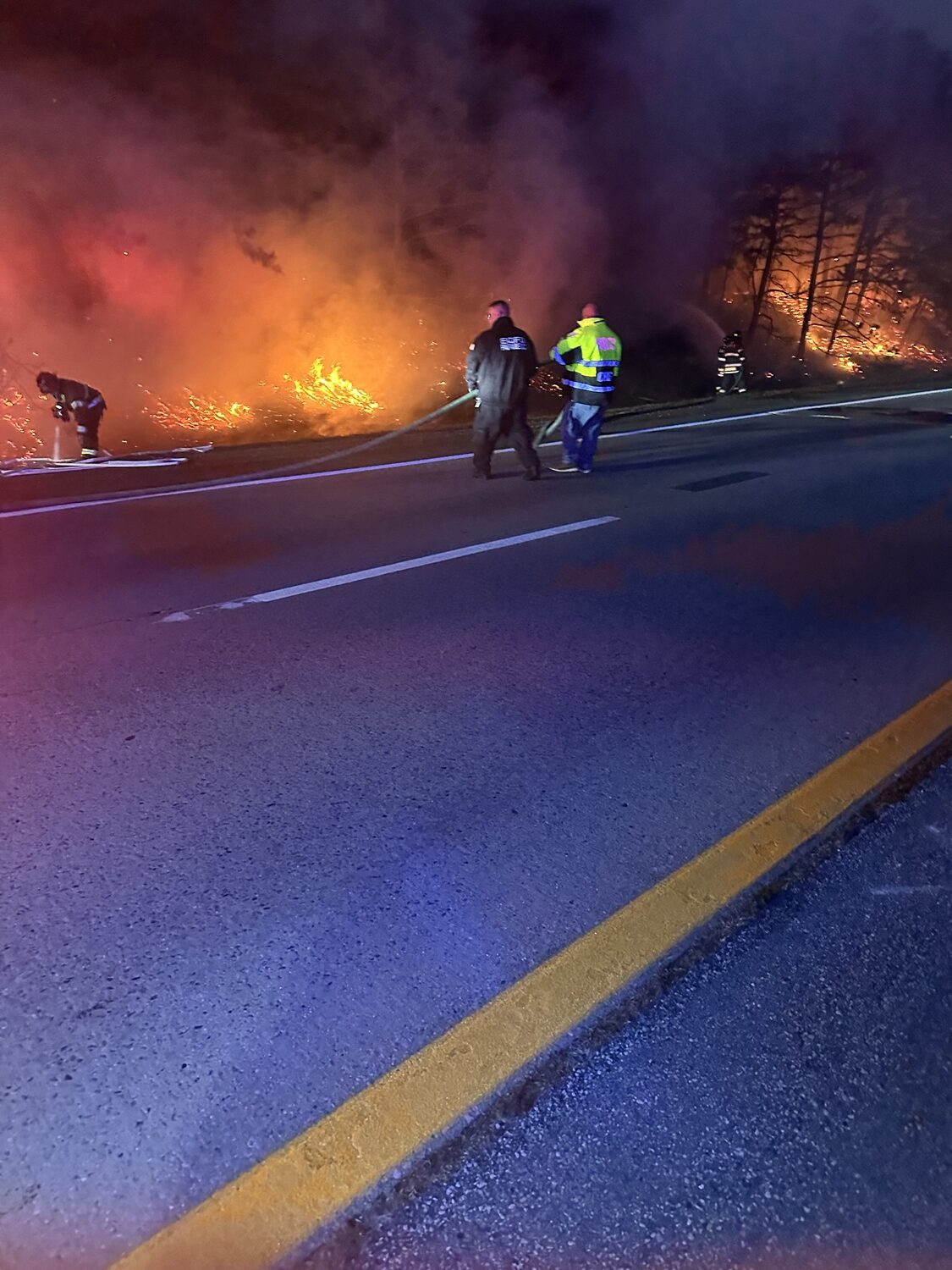 Firefighters from the East Quogue and Hampton Bays fire departments battled a brush fire that broke out on the side of Sunrise Highway on Monday evening. Despite high winds and dry conditions they departments were able to contain and extinguish the fire.