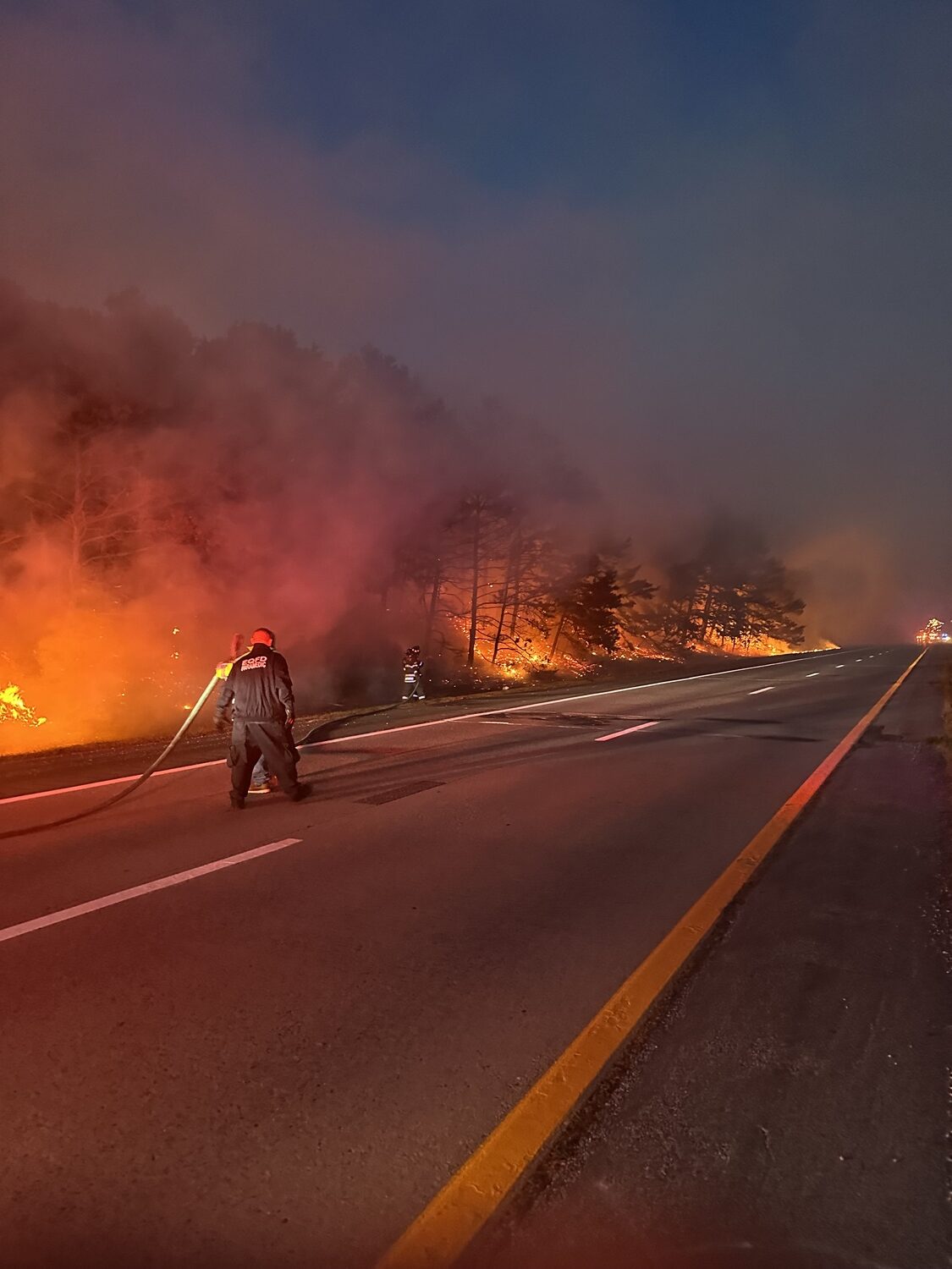 Firefighters from the East Quogue and Hampton Bays fire departments battled a brush fire that broke out on the side of Sunrise Highway on Monday evening. Despite high winds and dry conditions they departments were able to contain and extinguish the fire.