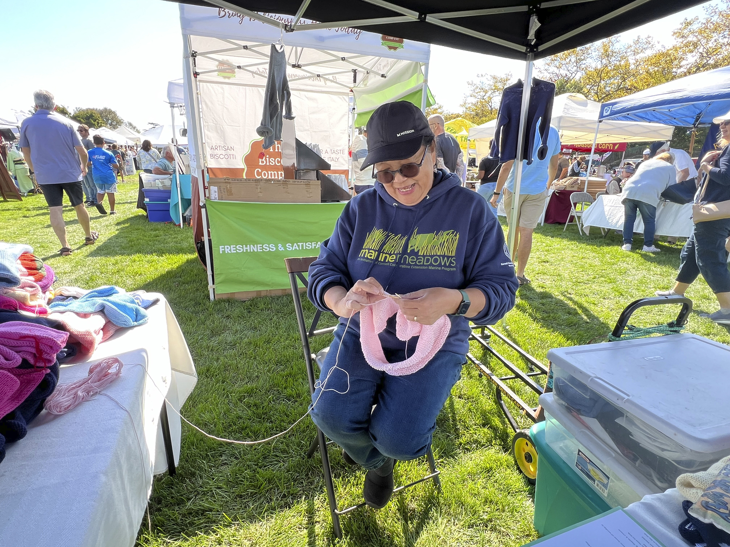 Yu Lu-Bouvier of Lulu Knits! works on a sweater in Agawam Park during SouthamptonFest.