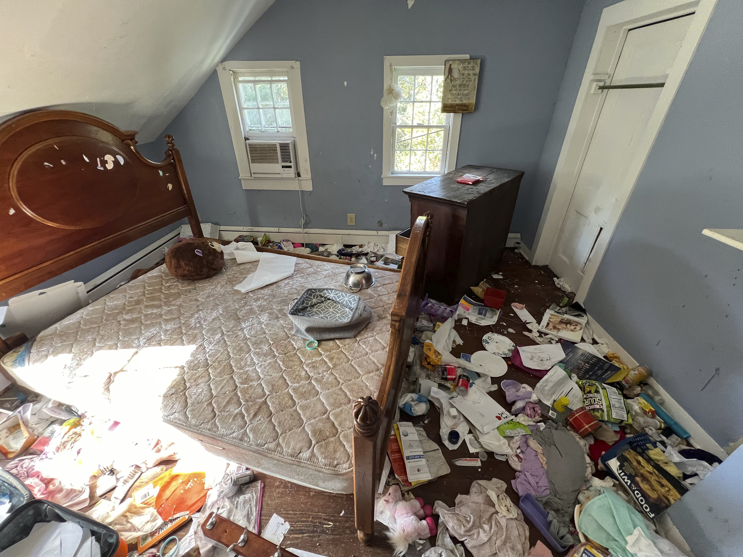 An upstairs bedroom of the home is strewn with garbage and furniture is damaged.  DANA SHAW