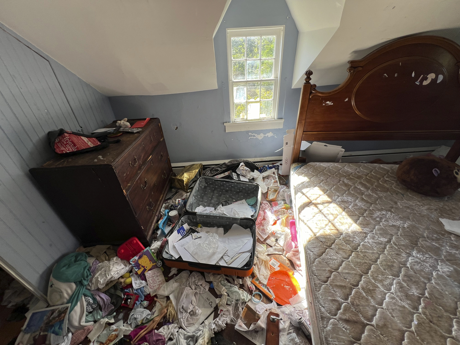 An upstairs bedroom of the home is strewn with garbage and furniture is damaged.  DANA SHAW