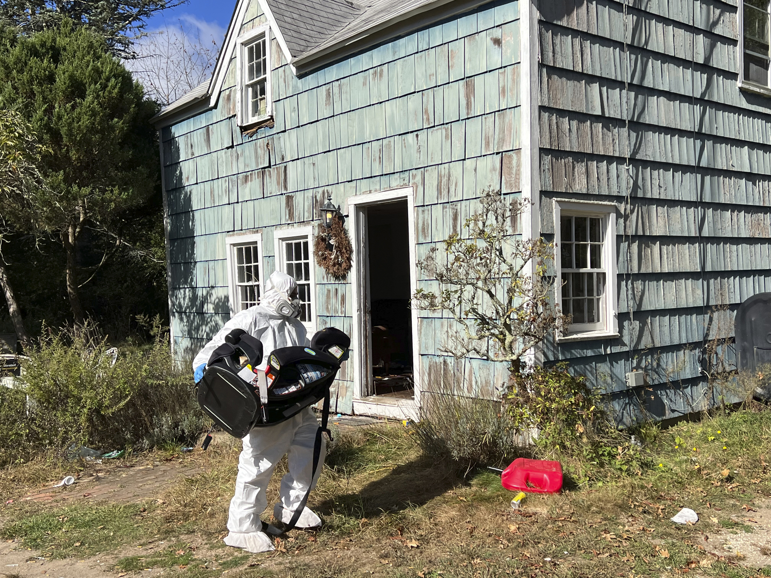 Workers in protective clothing began removing items from the home on October 10.  DANA SHAW