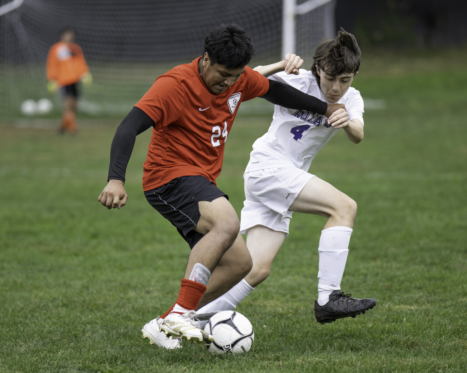 Allan Osorto and a Port Jeff player get tied up as they both go for the ball. MARIANNE BARNETT