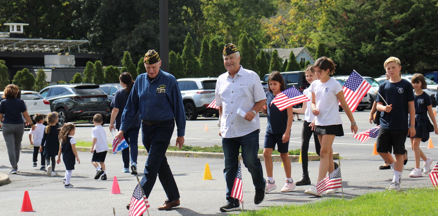 VFW POST 5350, along with 106th Rescue Win,g and the staff and students at Raynor Country Day School marched in support of those suffering from PTSD. The goal was to bring awareness to the alarming suicide rate among veterans, which often stems from PTSD, although the event focused on veteran struggles without highlighting suicide because of the many young children participating. COURTESY BILL HUGHES