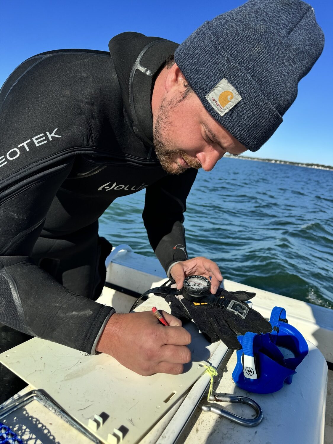 The scientists keep meticulous track of the growth and mortality rates of each strain of scallop raised in separate cages on the bay bottoms at several locations throughout the Peconics. MICHAEL WRIGHT