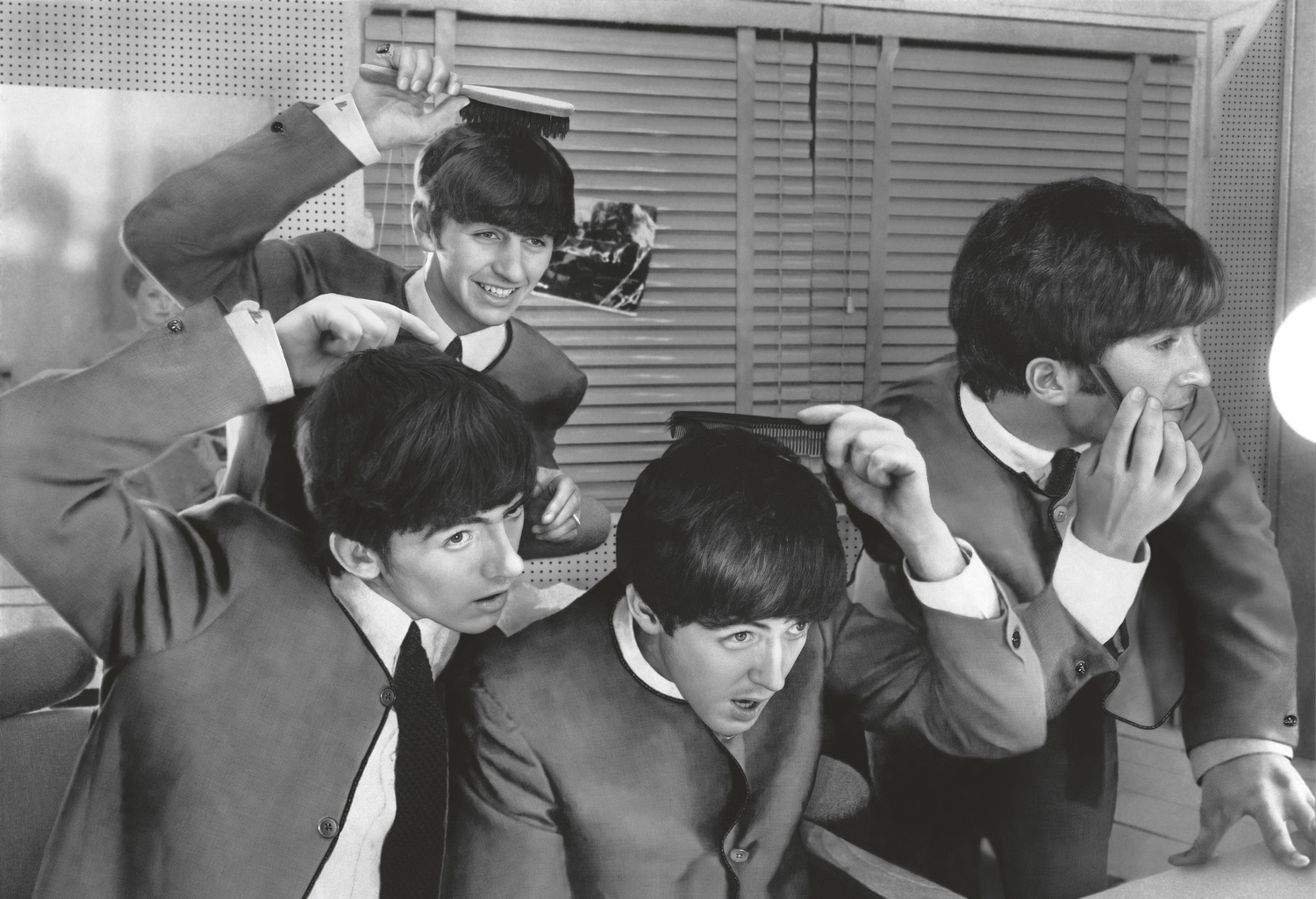 The Beatles, 1960s. Photographer Terry O’Neill captured a playful moment of the bandmates in their Cardin suits. TERRY O'NEILL/ICONIC IMAGES