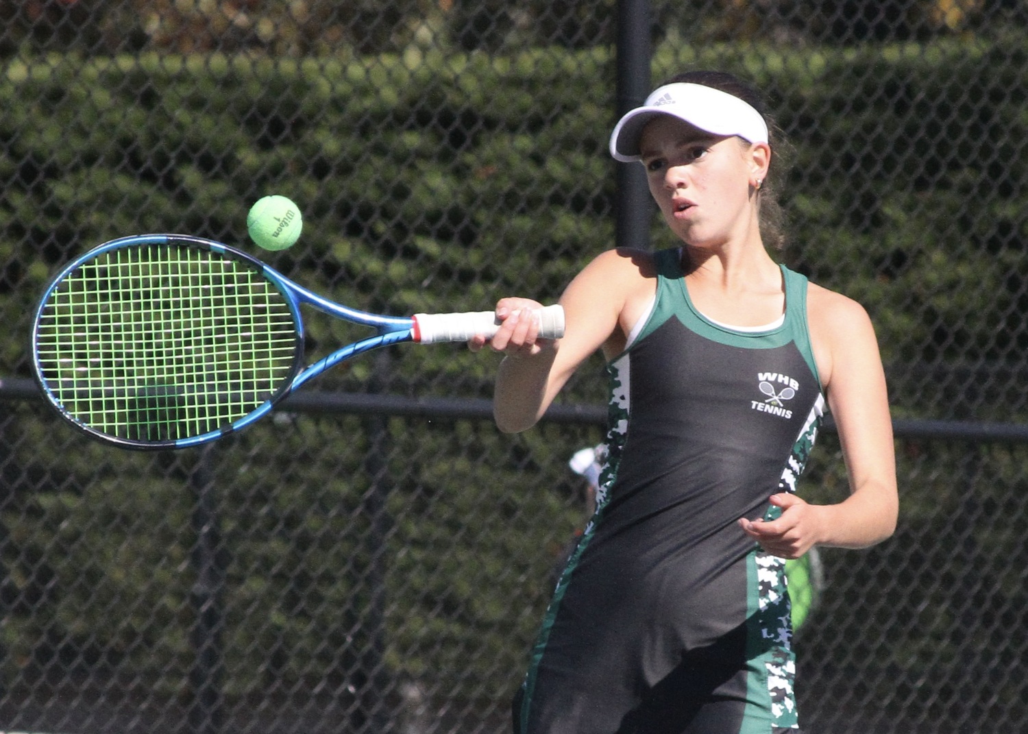 Eight-grader Gabby Arango powers the ball back over the net. DESIRÉE KEEGAN