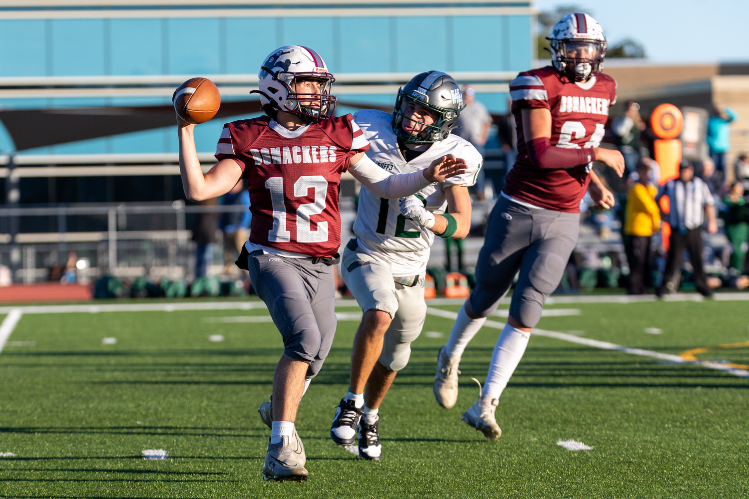 East Hampton quarterback Theo Ball gets ready to throw the ball as he's being rushed by Westhampton Beach senior Brody Schaffer.   RON ESPOSITO