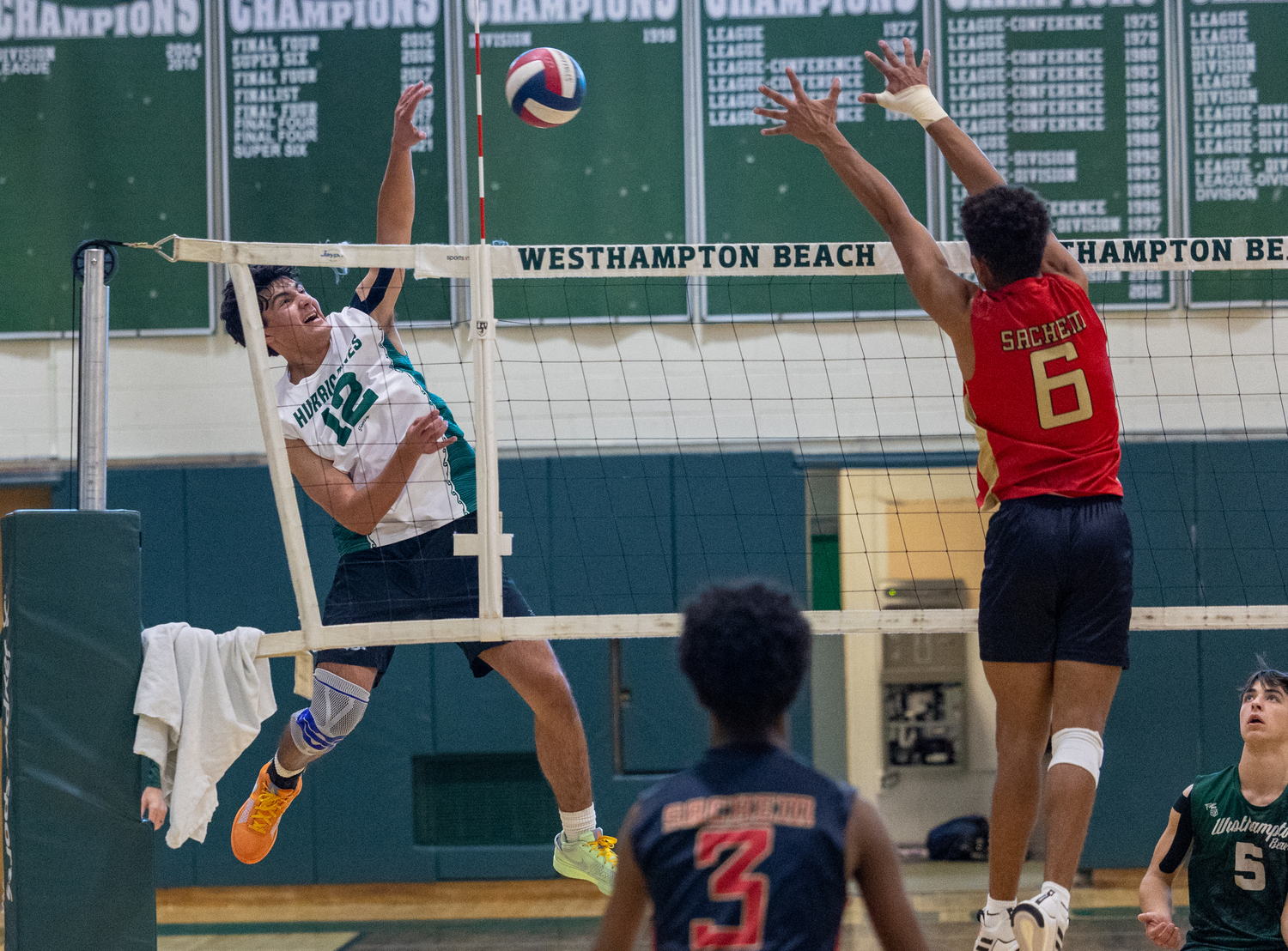 Junior right side Jude Allen slams the ball over the net. RON ESPOSITO