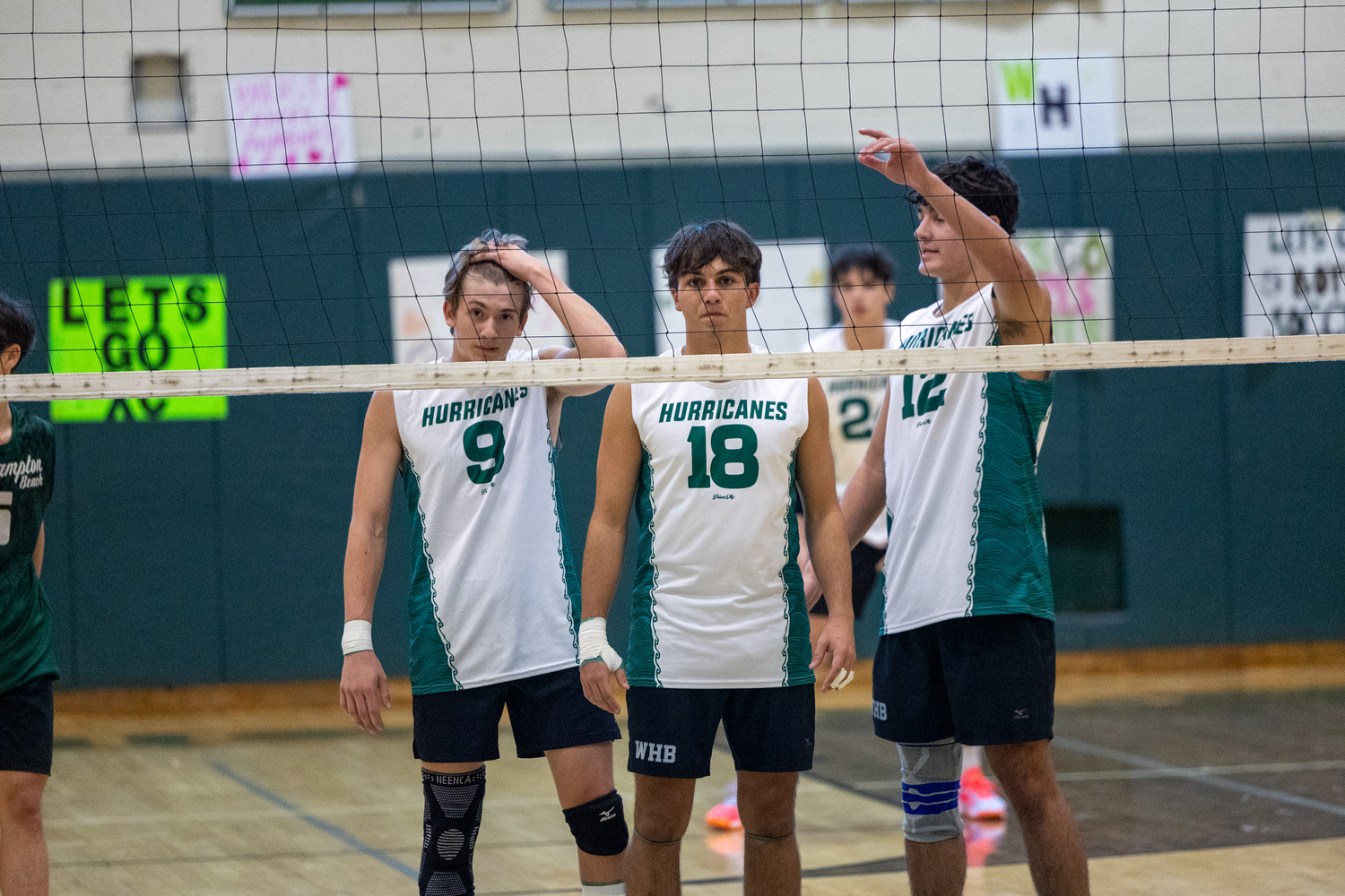 Junior outside hitter Thomas Livia, senior middle blocker James Monserrate and junior right side Jude Allen line up at the net. RON ESPOSITO