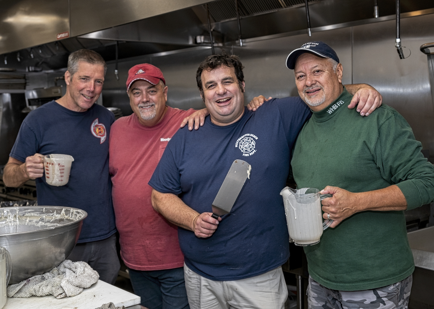 The Westhampton Beach Fire Department Juniors and Ladies Auxiliary hosted a pancake breakfast at the Sunset Avenue Firehouse on Sunday, October 6. The event was a fundraiser for a local food pantry. Volunteers in the kitchen included, from left, firefighters Jim Ostensen, Rob DeStefano, Jamie Santo, and Mario Mendoza. COURTESY WESTHAMPTON BEACH FIRE DEPARTMENT