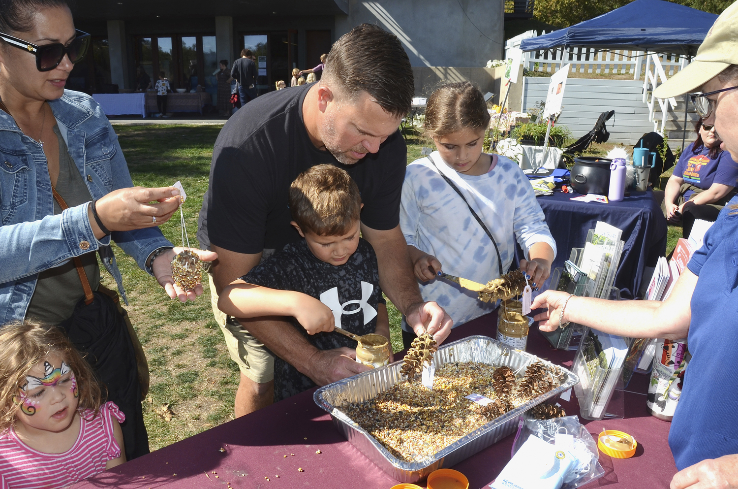 The Galbraith family makes bird feeders at the Long Pond Greenbelt 25th Annual Celebration on Saturday at the South Fork Natural History Museum on Saturday.  KYRIL BROMLEY