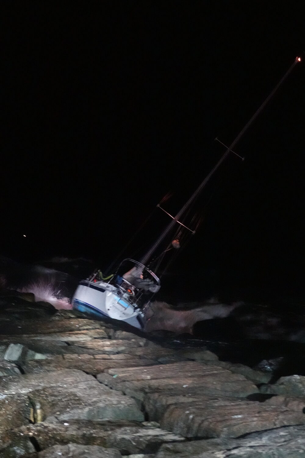 A 30 foot sailboat crashed into the east jetty of the Shinnecock Inlet on Tuesday night. The lone sailor aboard was uninjured and helped off the boat by nearby fishermen. The boat remained lodged on the rocks overnight with salvage crews expected to extract it on Wednesday morning. MICHAEL WRIGHT