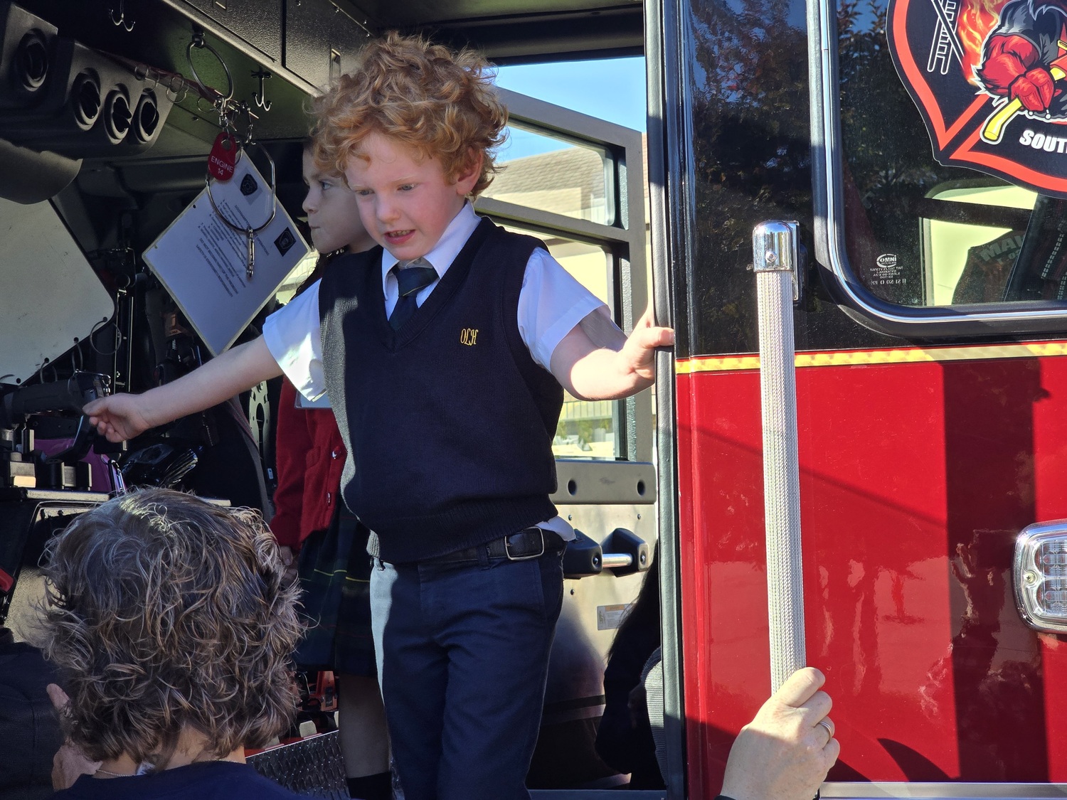 The Southampton Fire Department brought its red engines to Our Lady of the Hamptons School for a fire safety program. Students in kindergarten through third grade leaned 
strategies for safety, especially in the
home, as well as the work of firefighters. COURTESY OUR LADY OF THE HAMPTONS SCHOOL