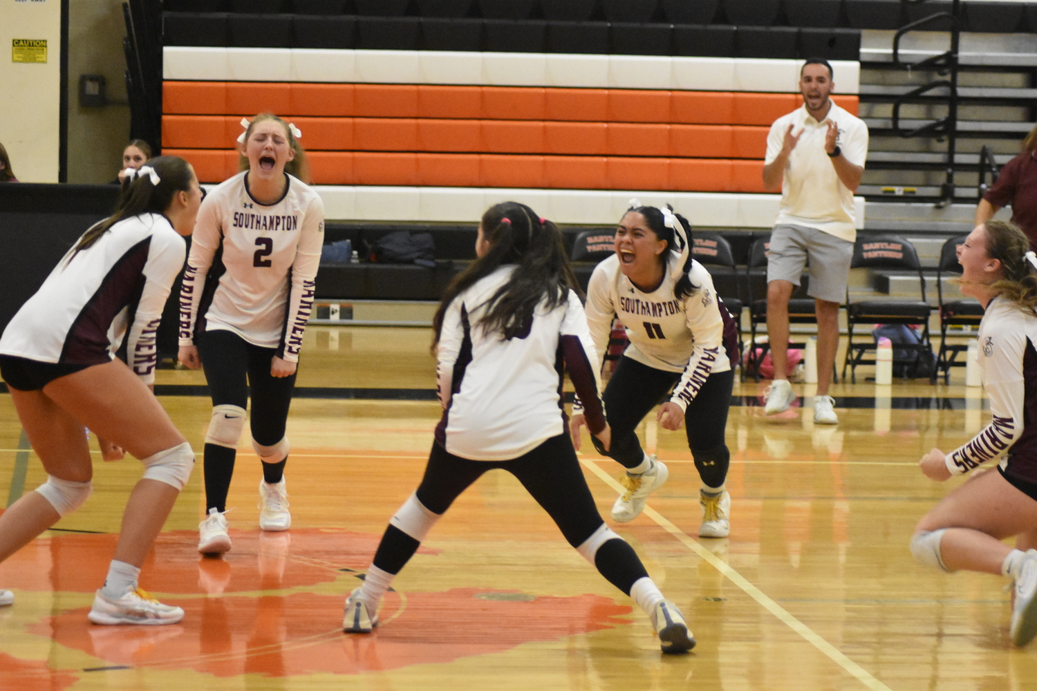 The Mariners are ecstatic after pulling out a 28-26 victory in the first set of Saturday's match.  DREW BUDD