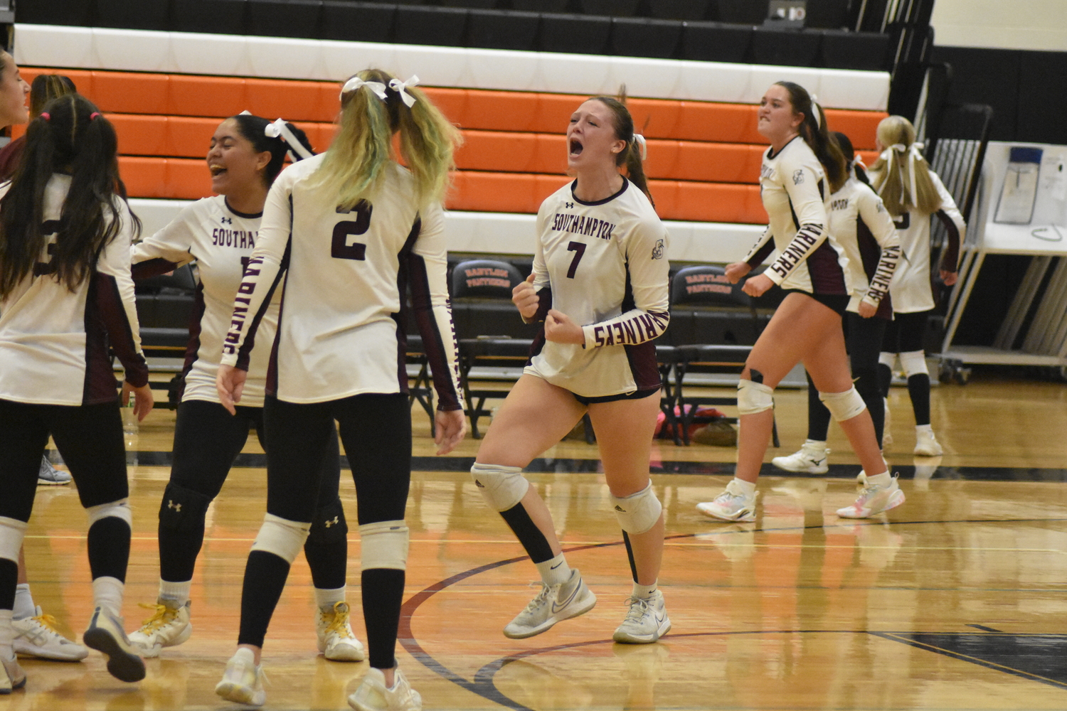 The Mariners are ecstatic after pulling out a 28-26 victory in the first set of Saturday's match.  DREW BUDD