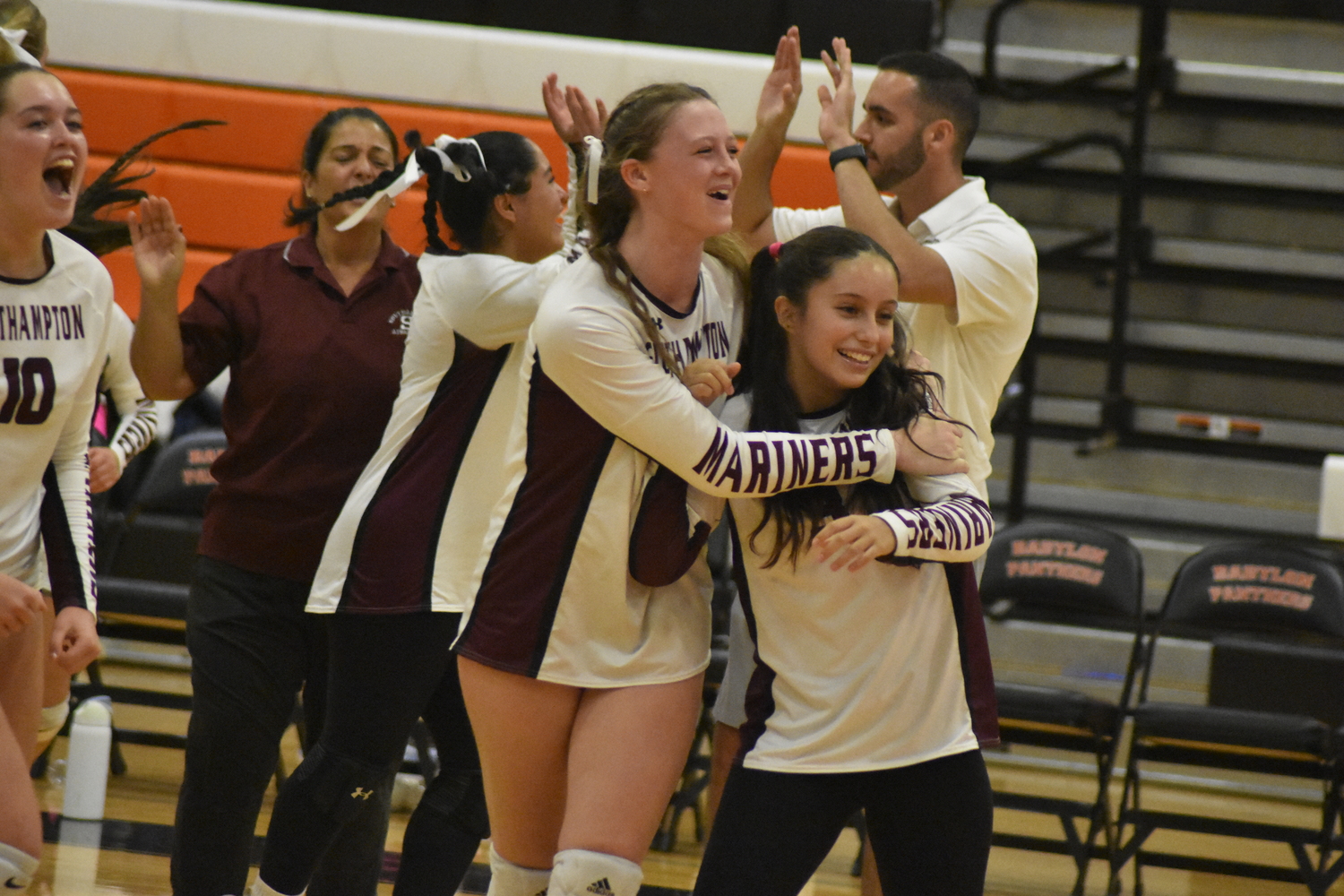 Bailey Brown, left, Danna Nieto and the rest of the Mariners are all smiles directly following their 3-1 playoff victory at Babylon on Saturday.  DREW BUDD