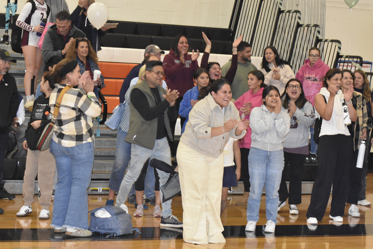 The Southampton crowd applauds its girls volleyball team after defeating host Babylon, 3-1, on Saturday.   DREW BUDD