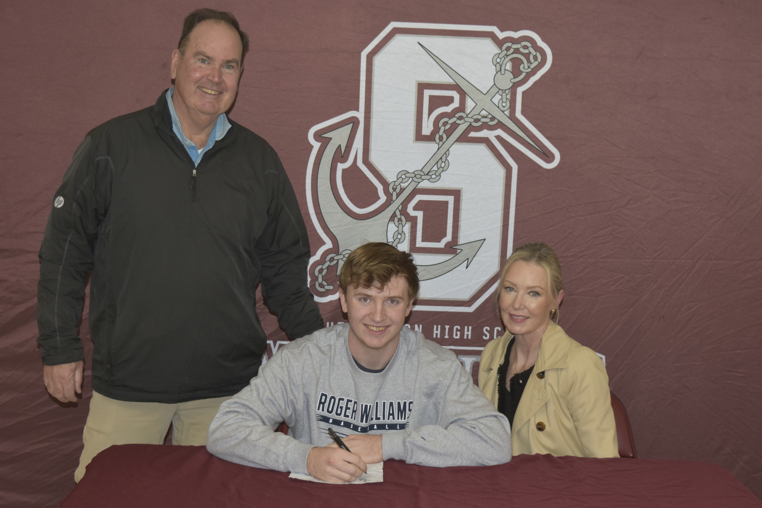 Southampton senior Daniel McDonnell, flanked by his parents Daniel and Kristen, signs his letter of intent to play baseball at Roger Williams University.    DREW BUDD