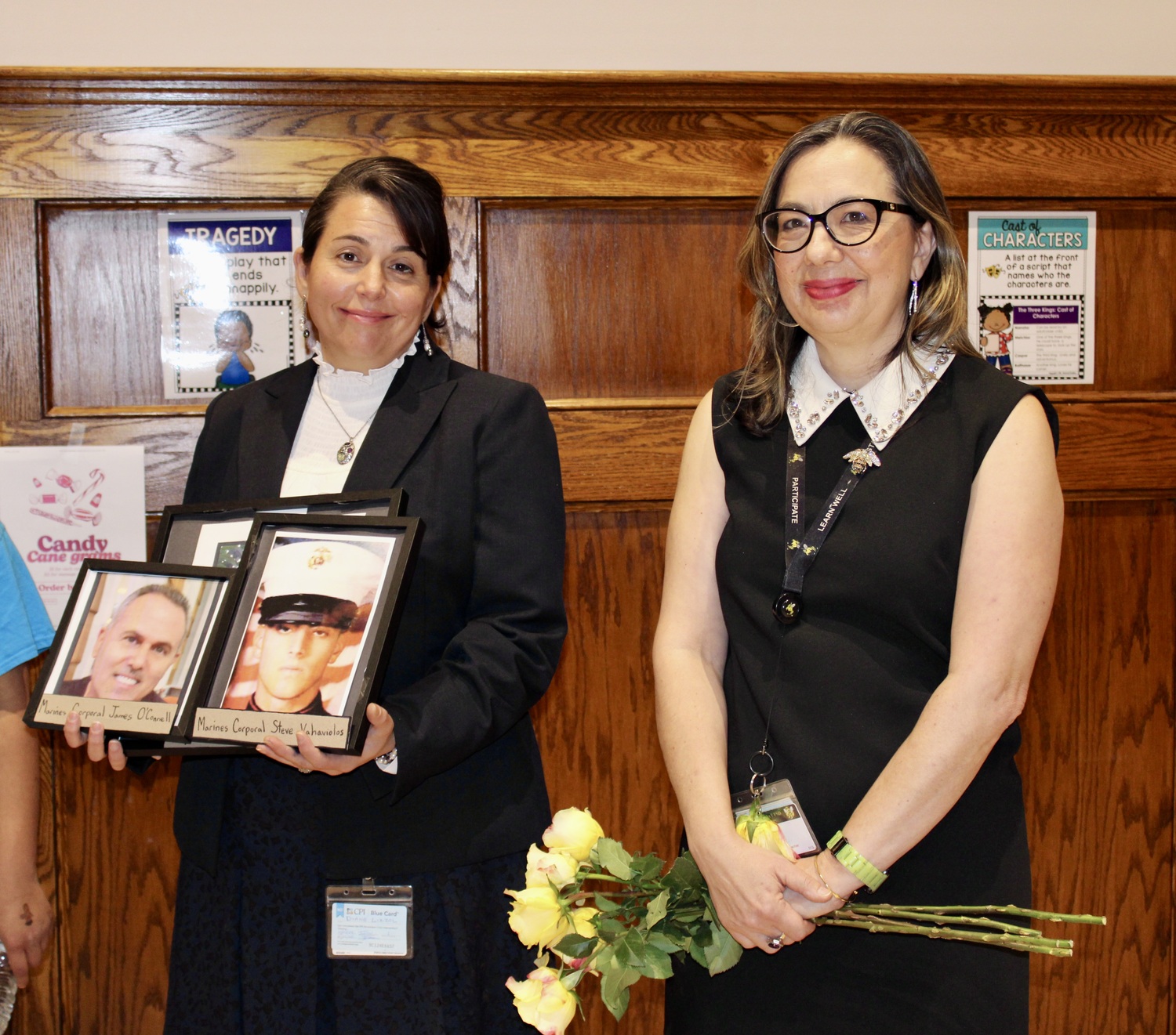 Foreign language teacher Diane Lizzol with photos of her veteran family members with organizer and Bridgehampton AIS ELA teacher Hamra Ozsu.